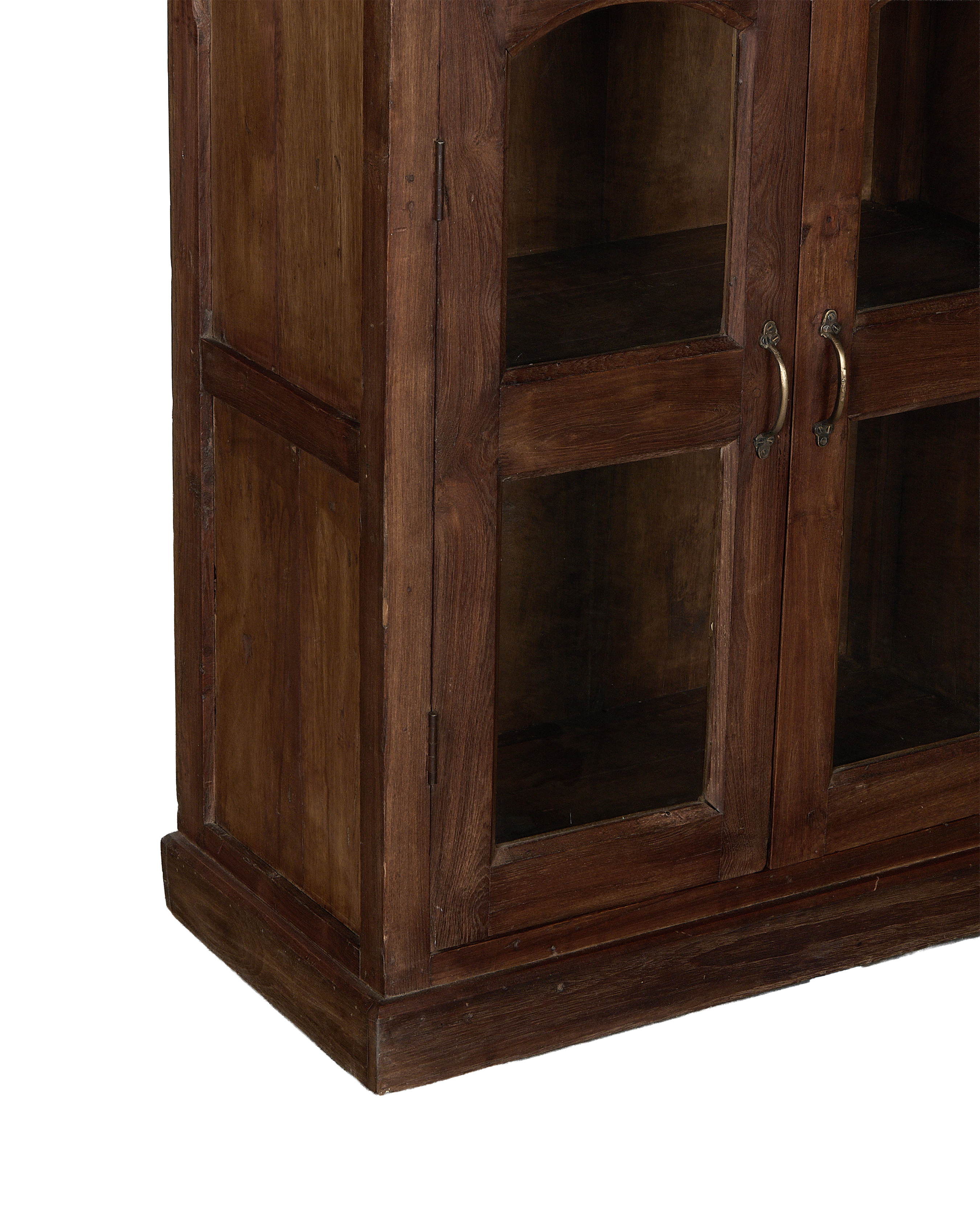 Vintage Indian oak wood cabinet, close-up of glass doors with antique brass handles.