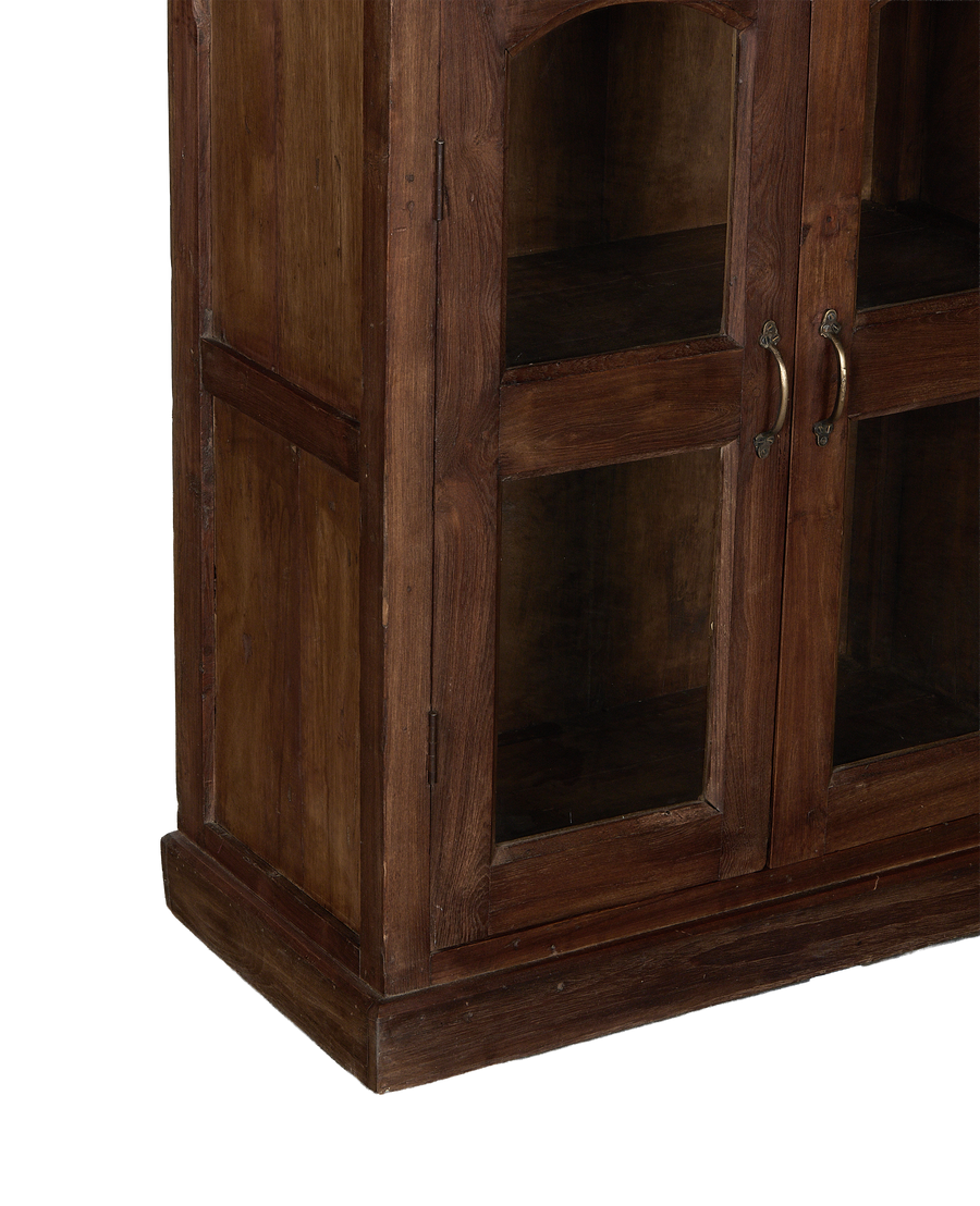 Vintage Indian oak wood cabinet, close-up of glass doors with antique brass handles.