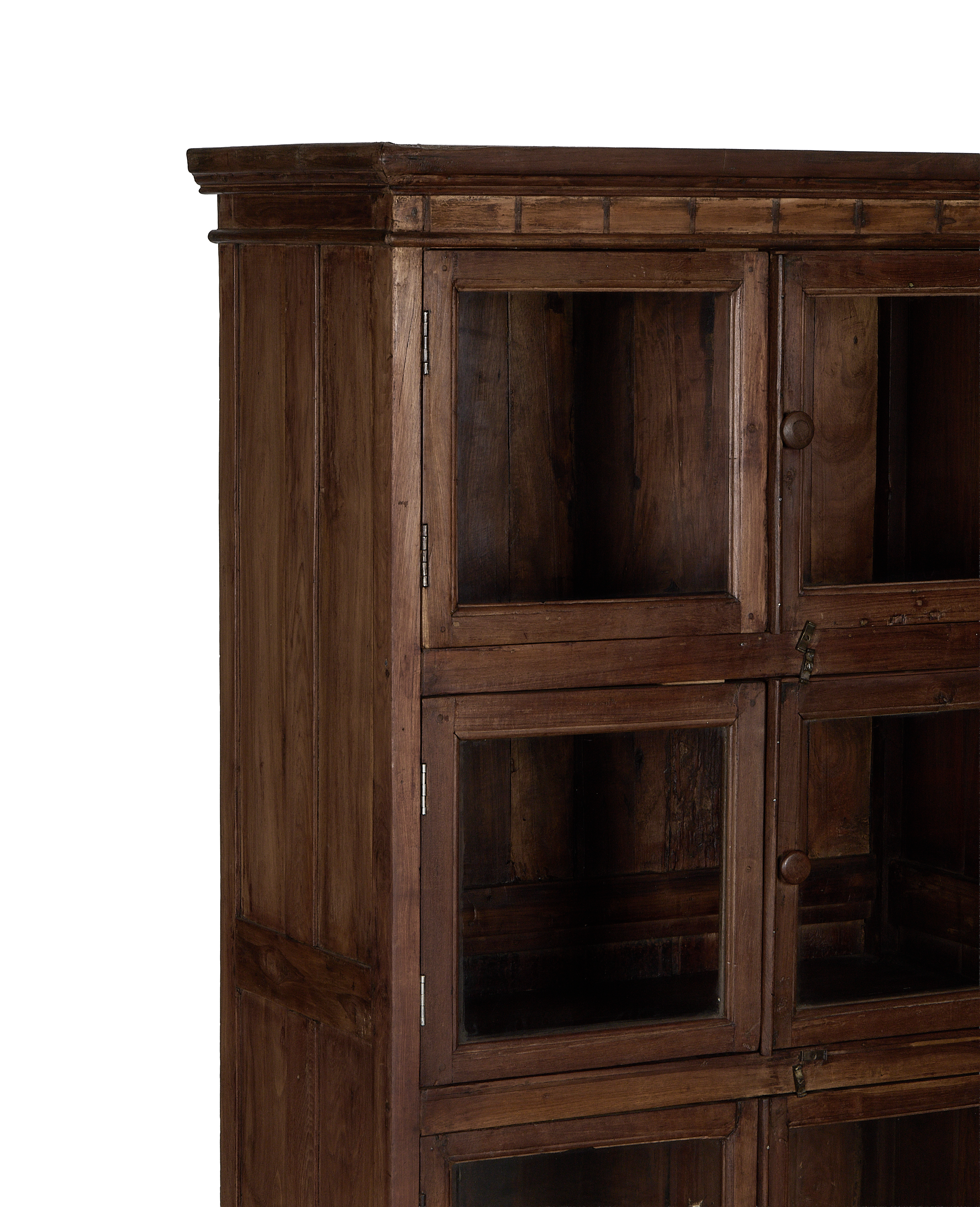 Vintage Indian natural oak cabinet, detail of glass doors, knob, and aged wood grain.