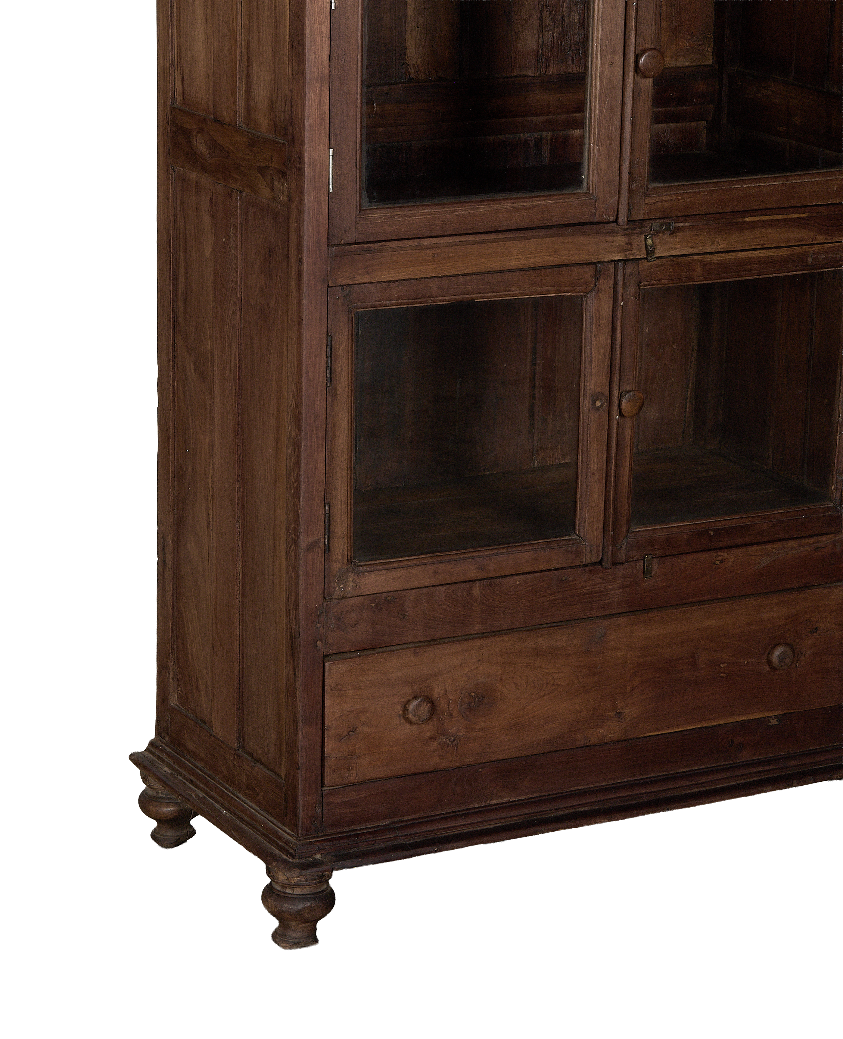 Vintage Indian oak wood cabinet, close-up showing lower glass doors and drawer with knobs.