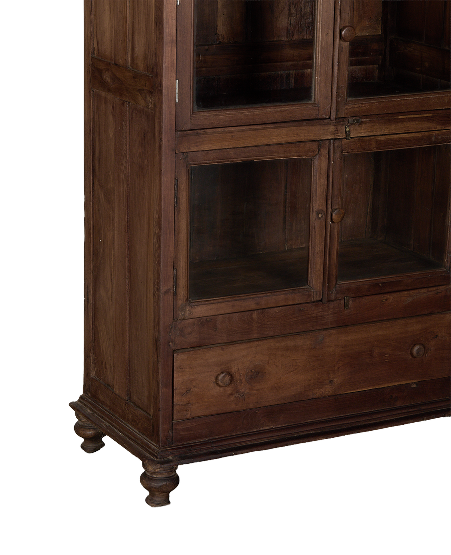 Vintage Indian oak wood cabinet, close-up showing lower glass doors and drawer with knobs.