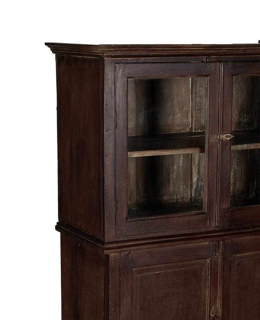 Vintage Indian stained oak wood cabinet featuring glass-fronted upper doors and bottom paneling.