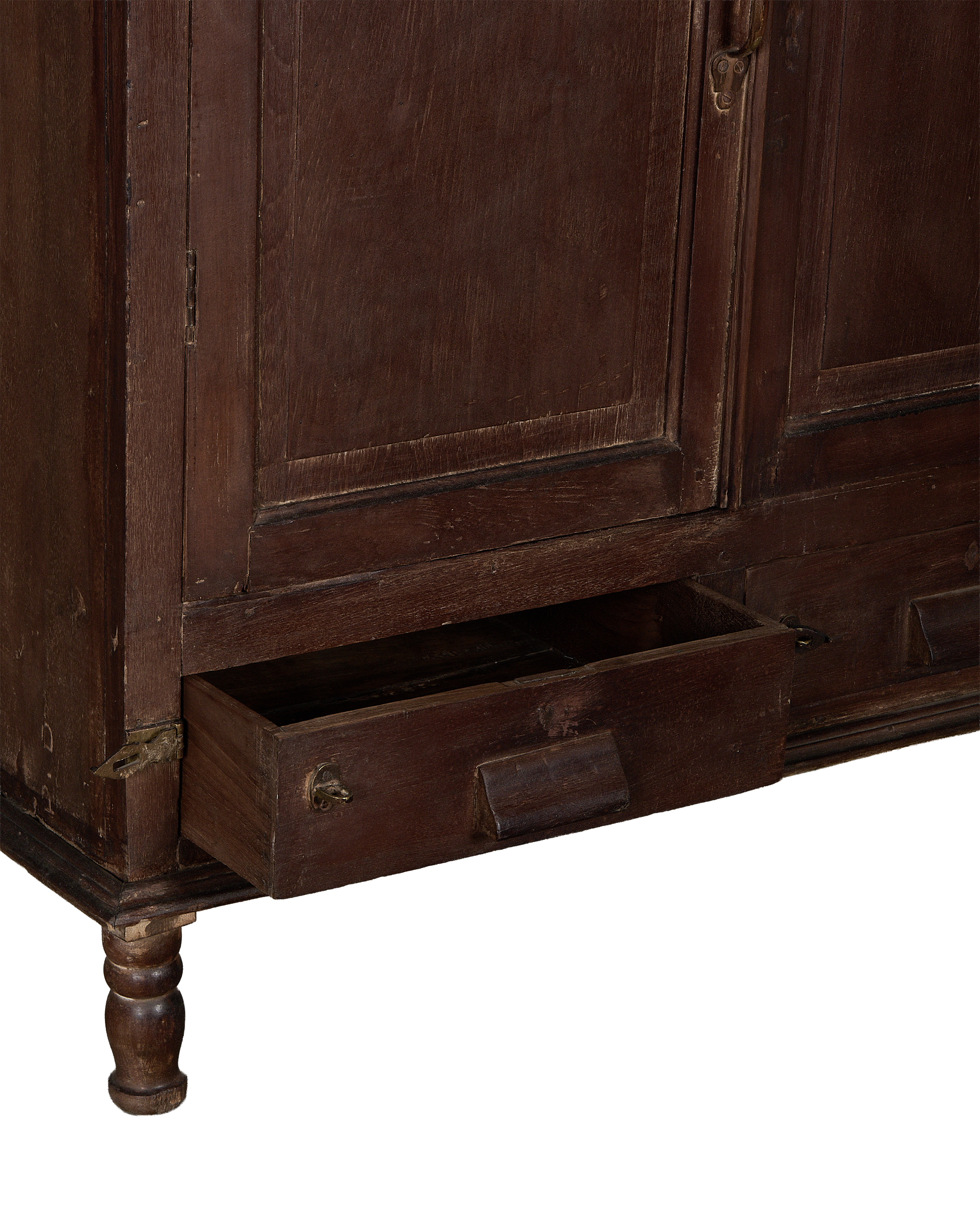 Vintage Indian oak cabinet, stained dark brown, with bottom drawer pulled open, revealing aged interior.