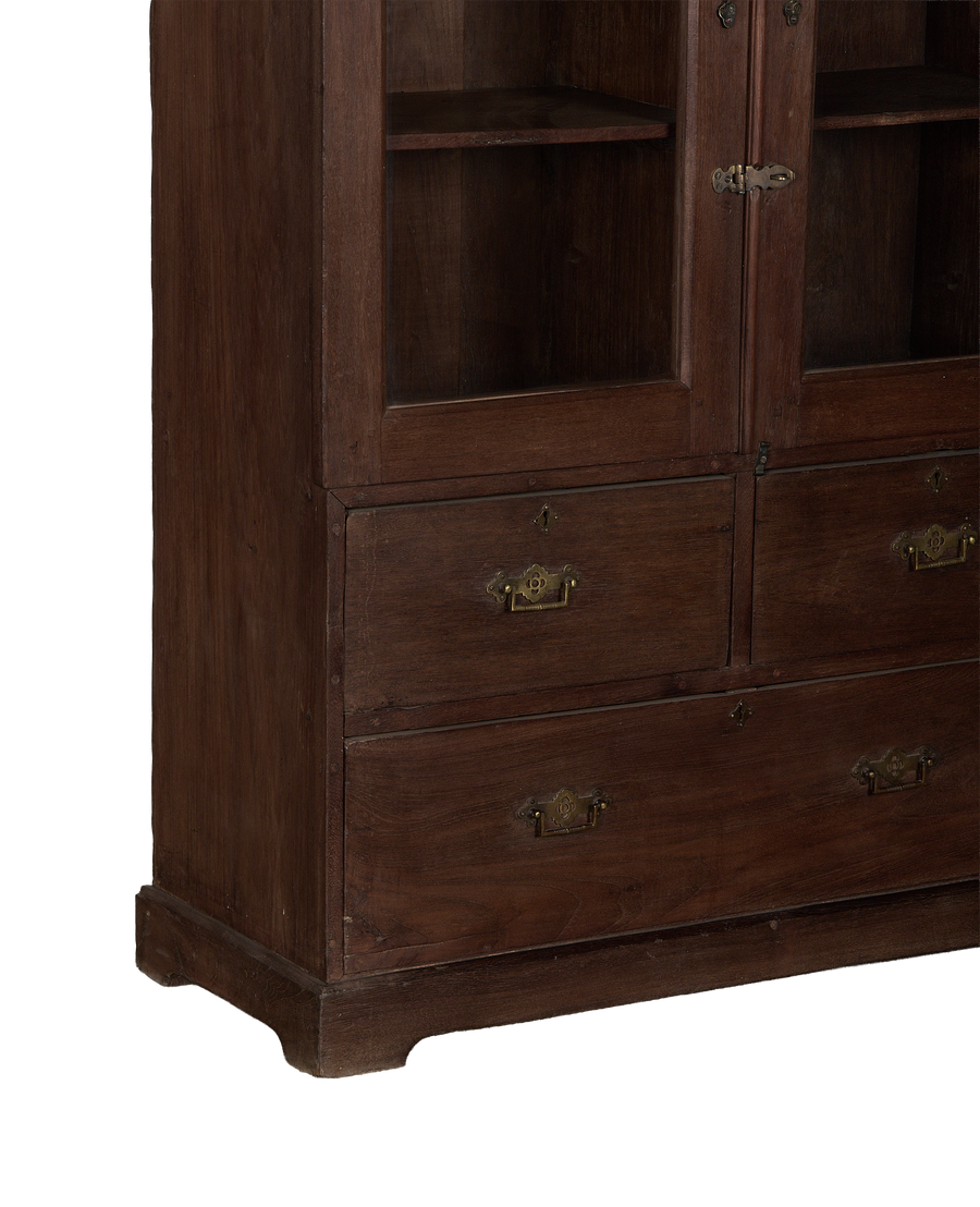 Vintage Indian oak cabinet details: glass doors, drawers with brass handles, carved base.