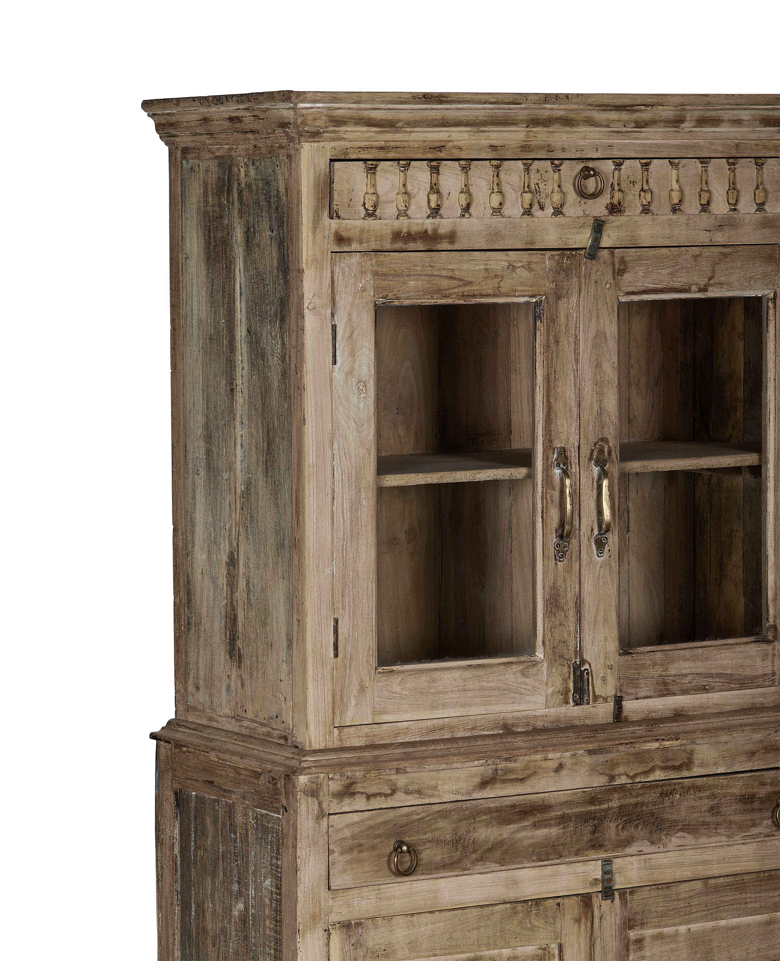 Vintage bleached oak cabinet from India, showing ornate carving and glass doors with brass handles.