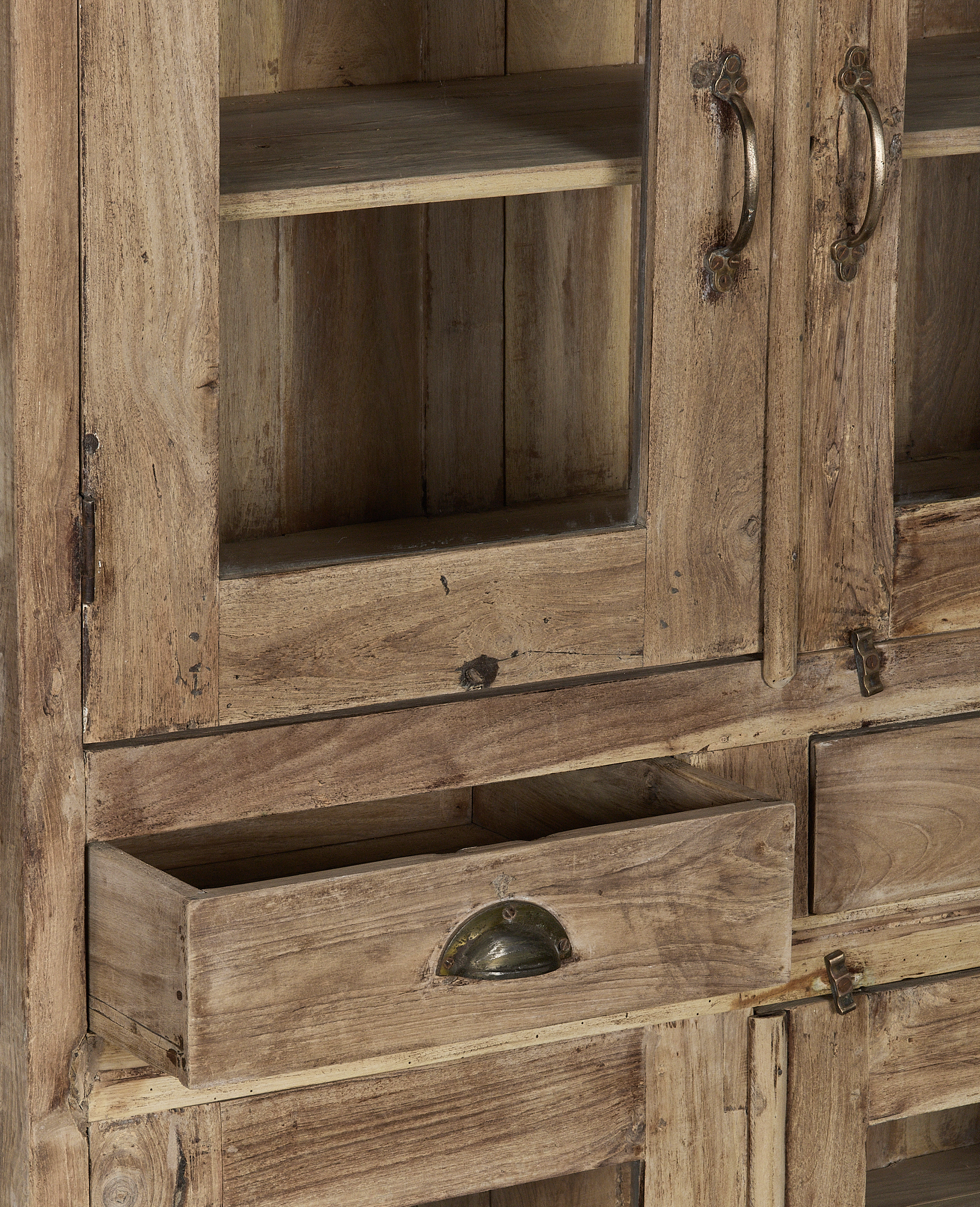 Vintage Indian oak cabinet detail, open drawer showing aged wood, patinated brass pull handle.