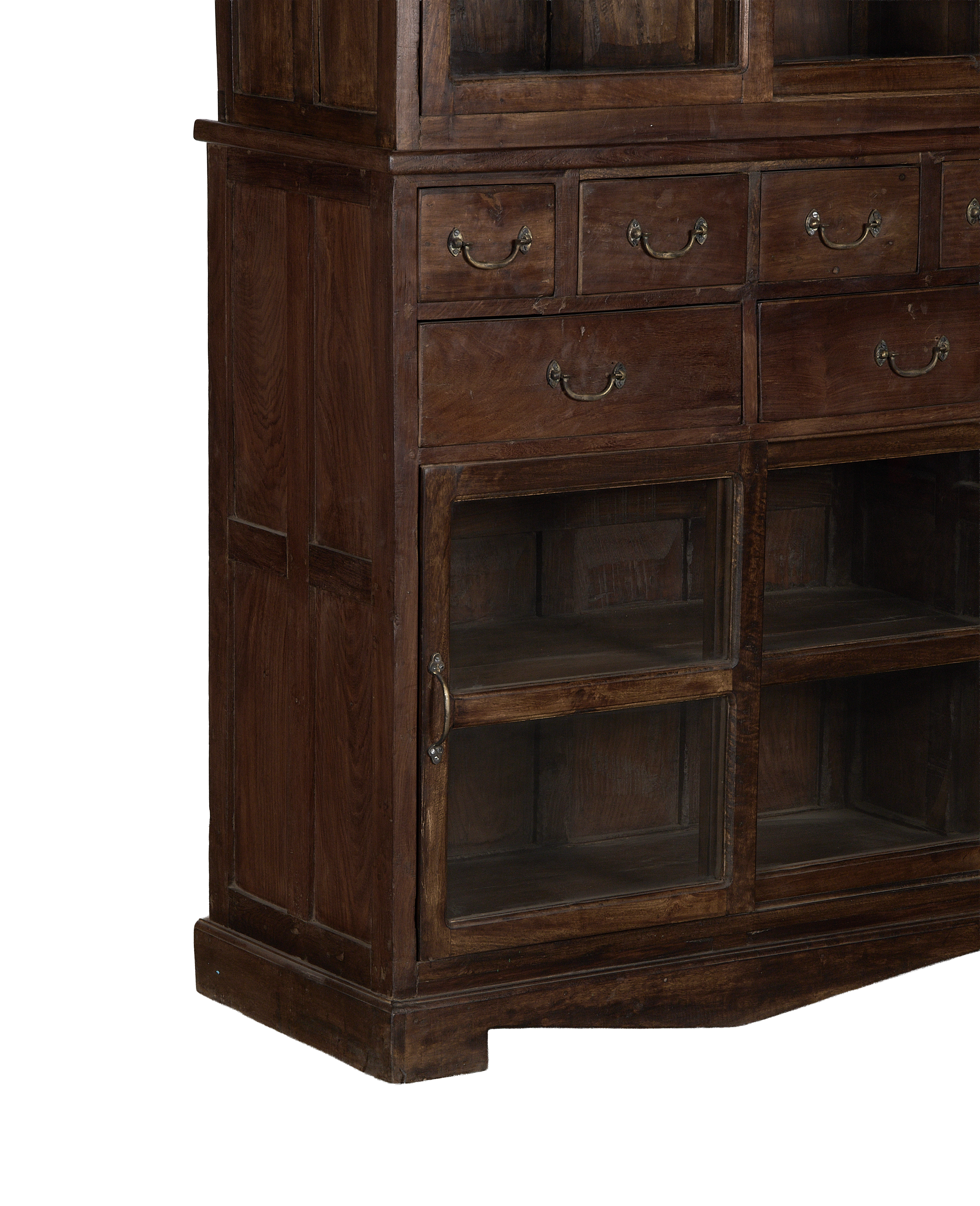 Vintage Indian oak cabinet: lower section with multiple glass doors and brass-handled drawers.