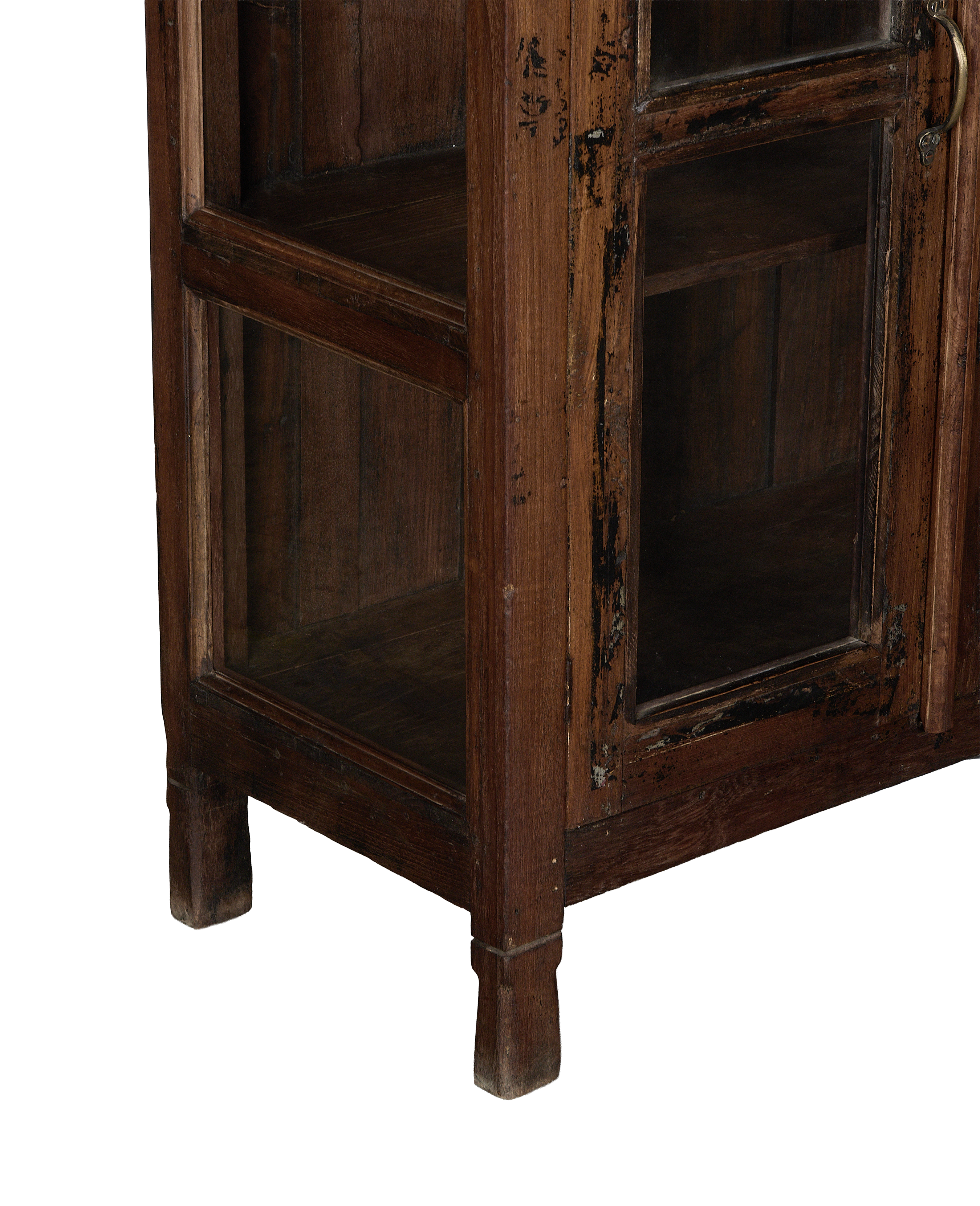 Vintage oak cabinet detail: worn wood frame, glass panels, bottom shelf, and single square leg.