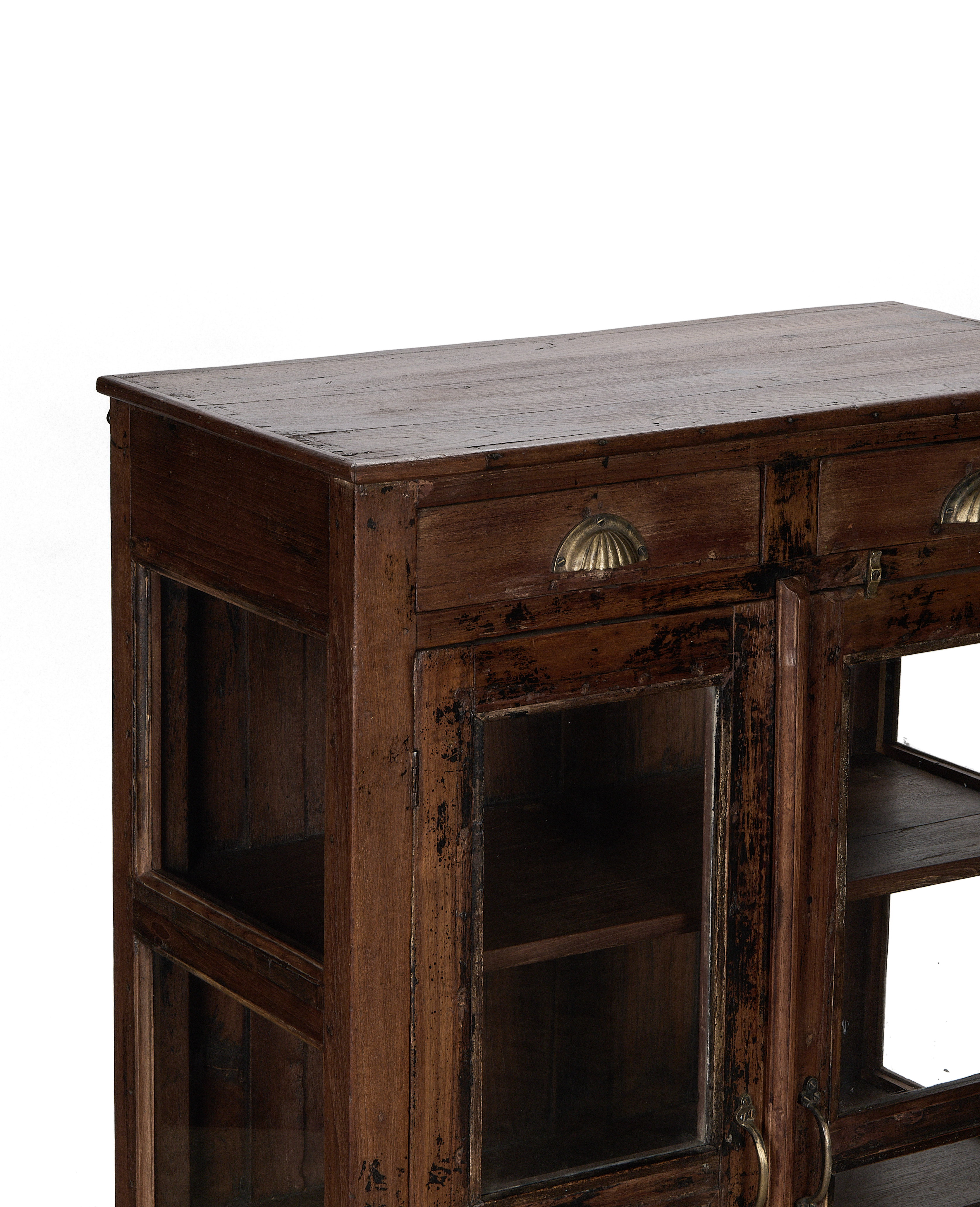 Close-up showing the vintage Indian oak cabinet's natural wood top and brass shell pulls.