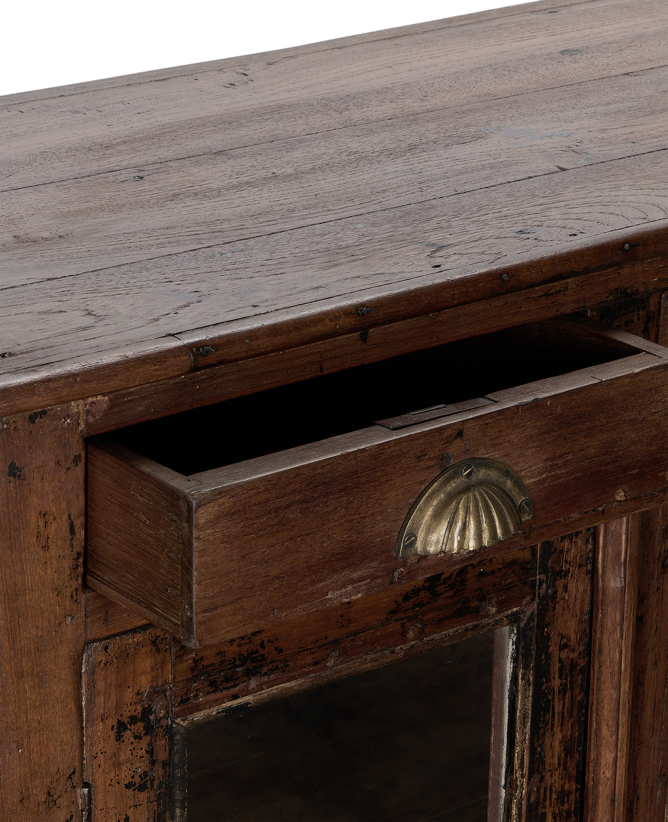 Vintage Indian oak cabinet, drawer open, showing aged brass scallop pull and dark distressed wood.