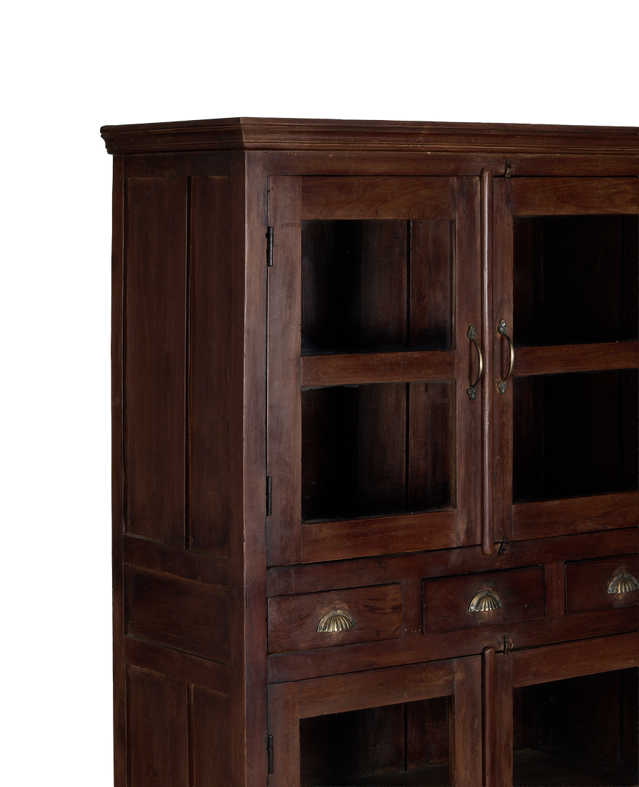 Vintage Indian oak cabinet featuring glass doors, brass hardware, and intricate molding detail.