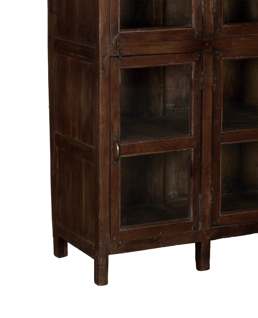 Vintage Indian oak wood cabinet, close-up of glass doors with aged brass pull.