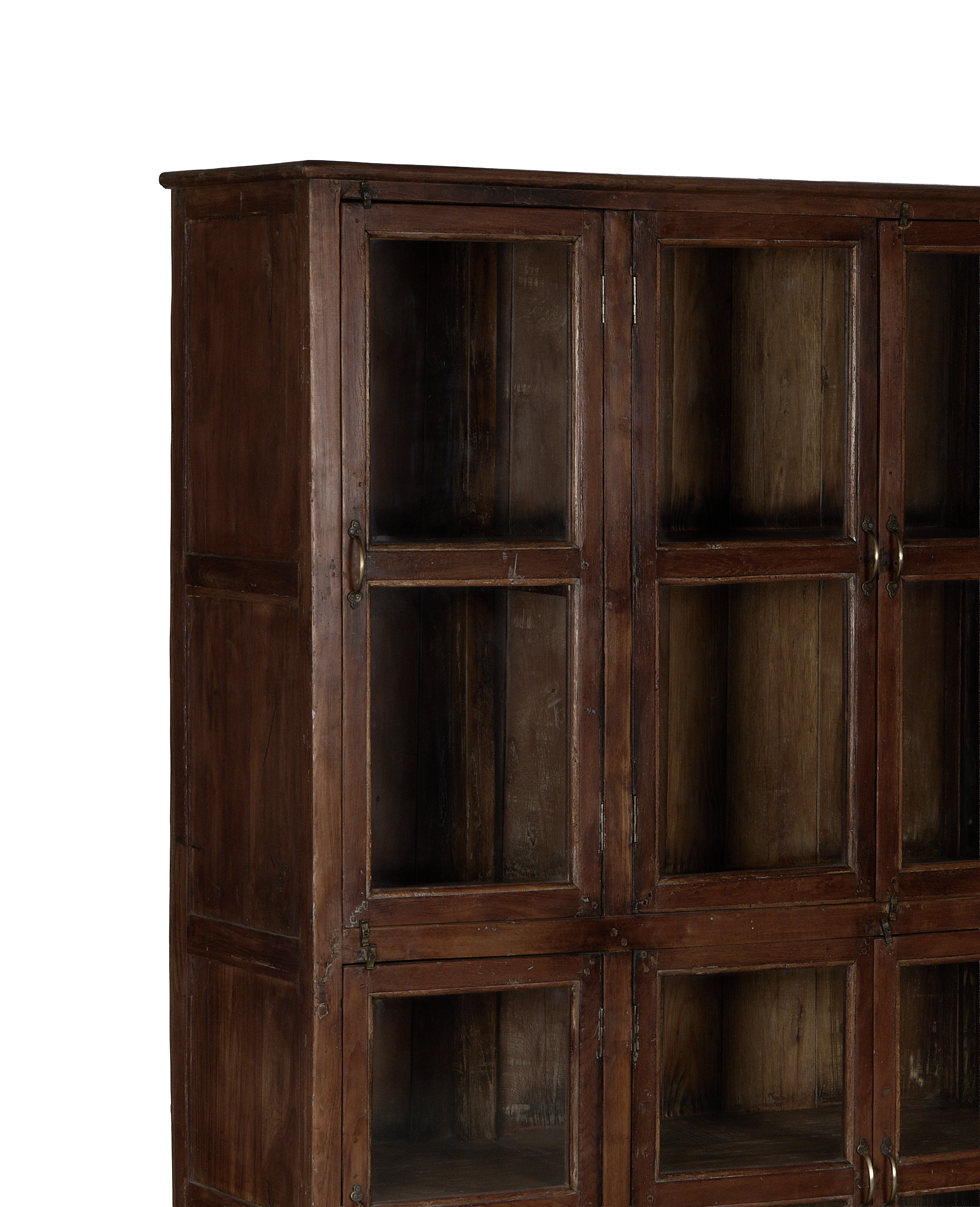 Vintage Indian oak wood cabinet, close-up of glass doors and aged brass handles.