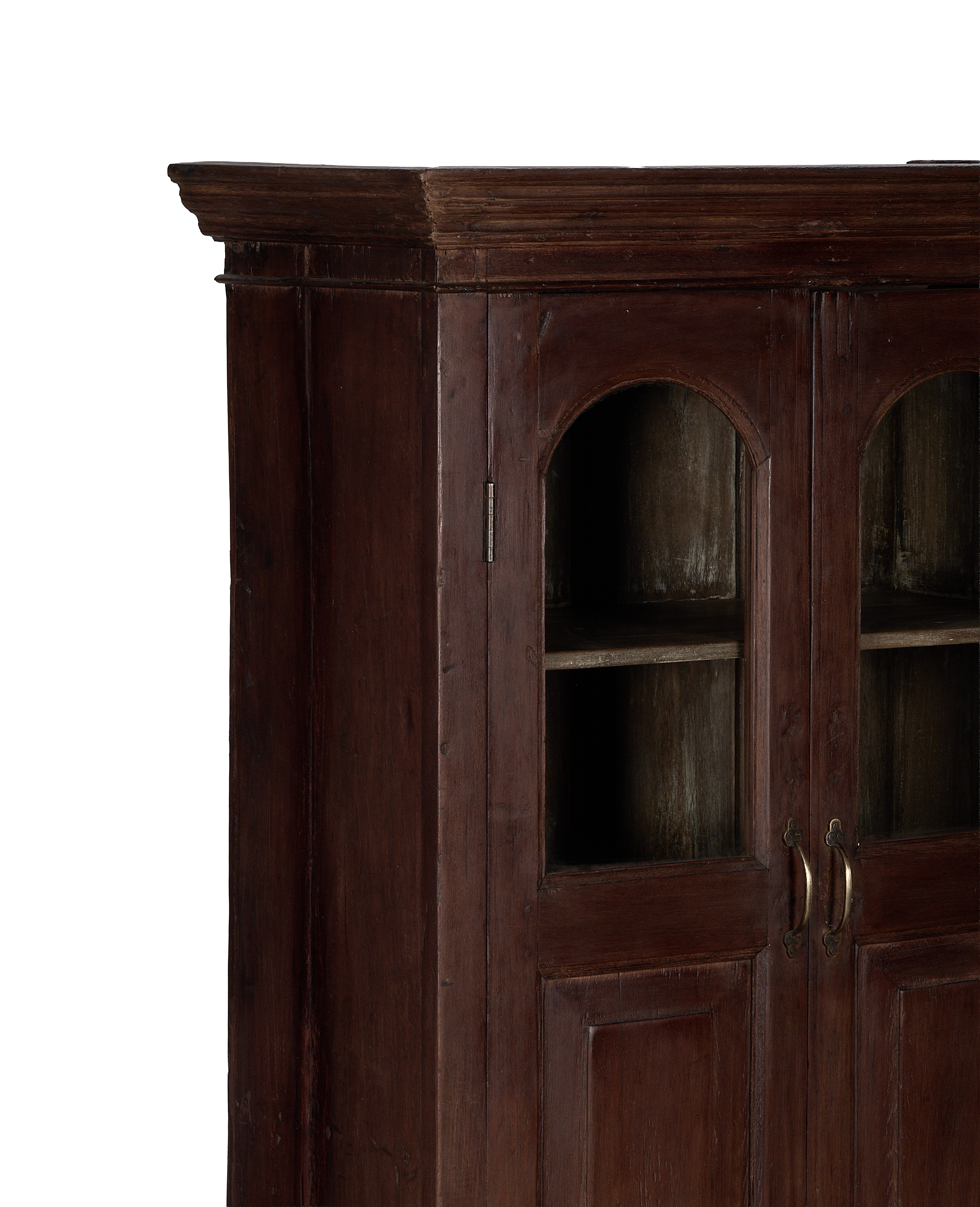 Vintage Indian oak cabinet: detailed view of arched glass doors and brass handles.