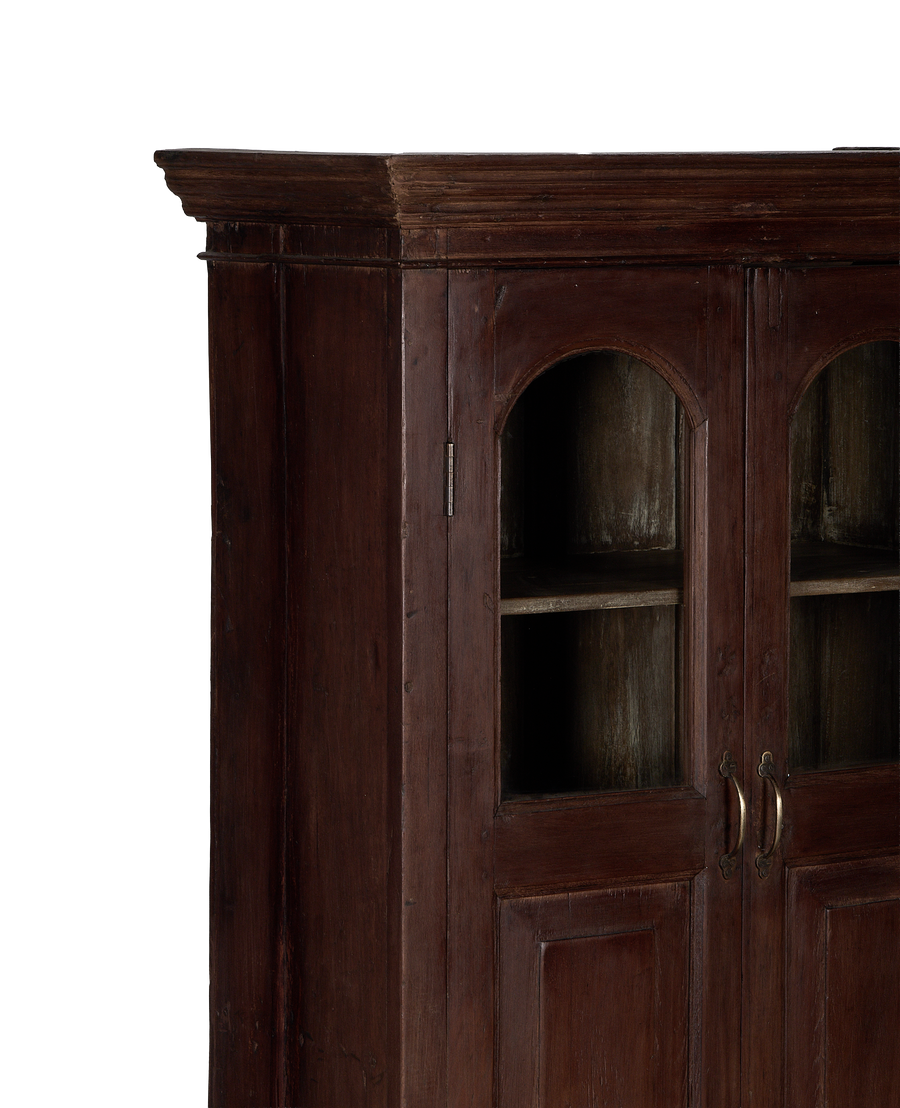 Vintage Indian oak cabinet: detailed view of arched glass doors and brass handles.