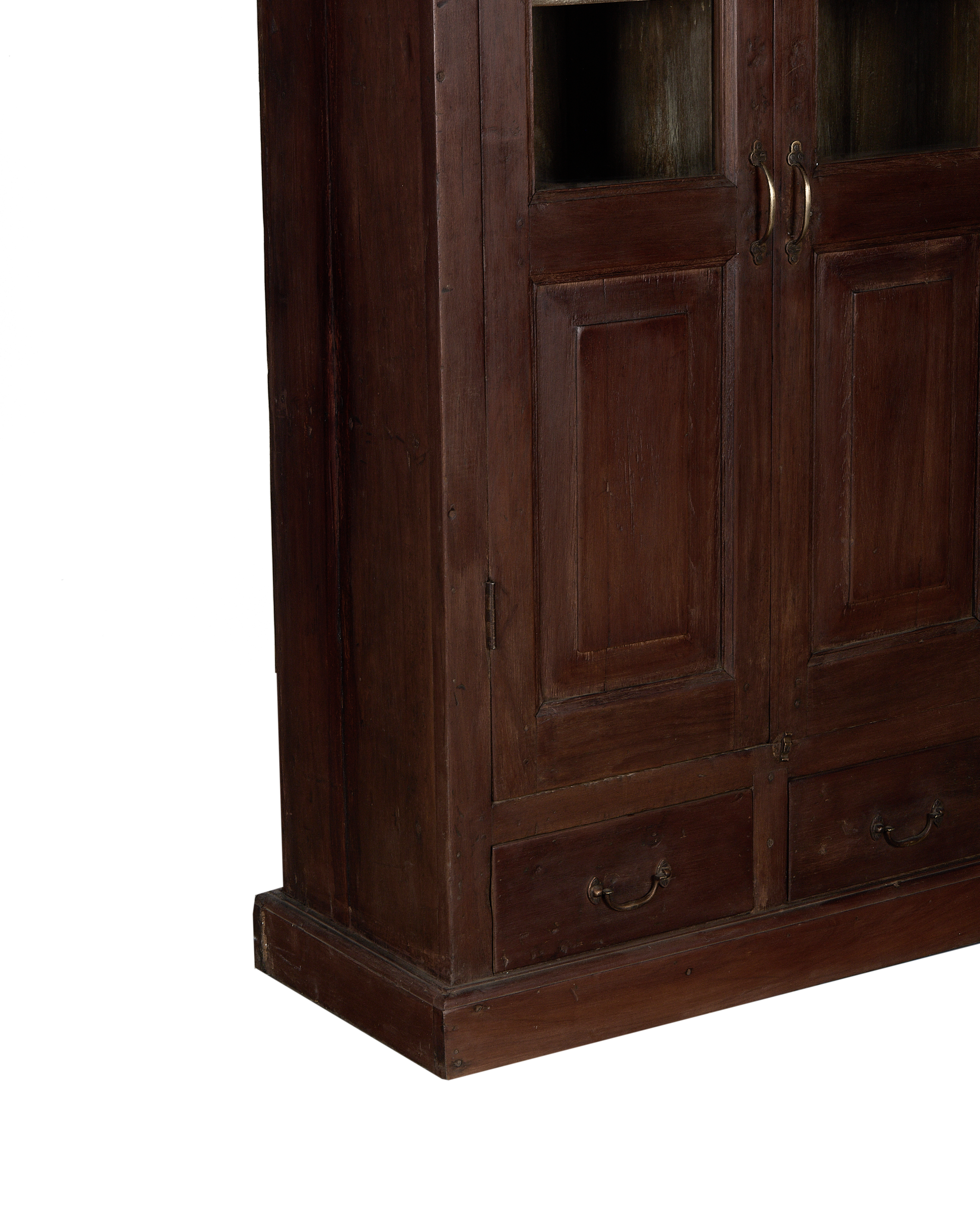 Vintage oak cabinet from India, showing bottom drawers with brass handles and rustic wood texture.