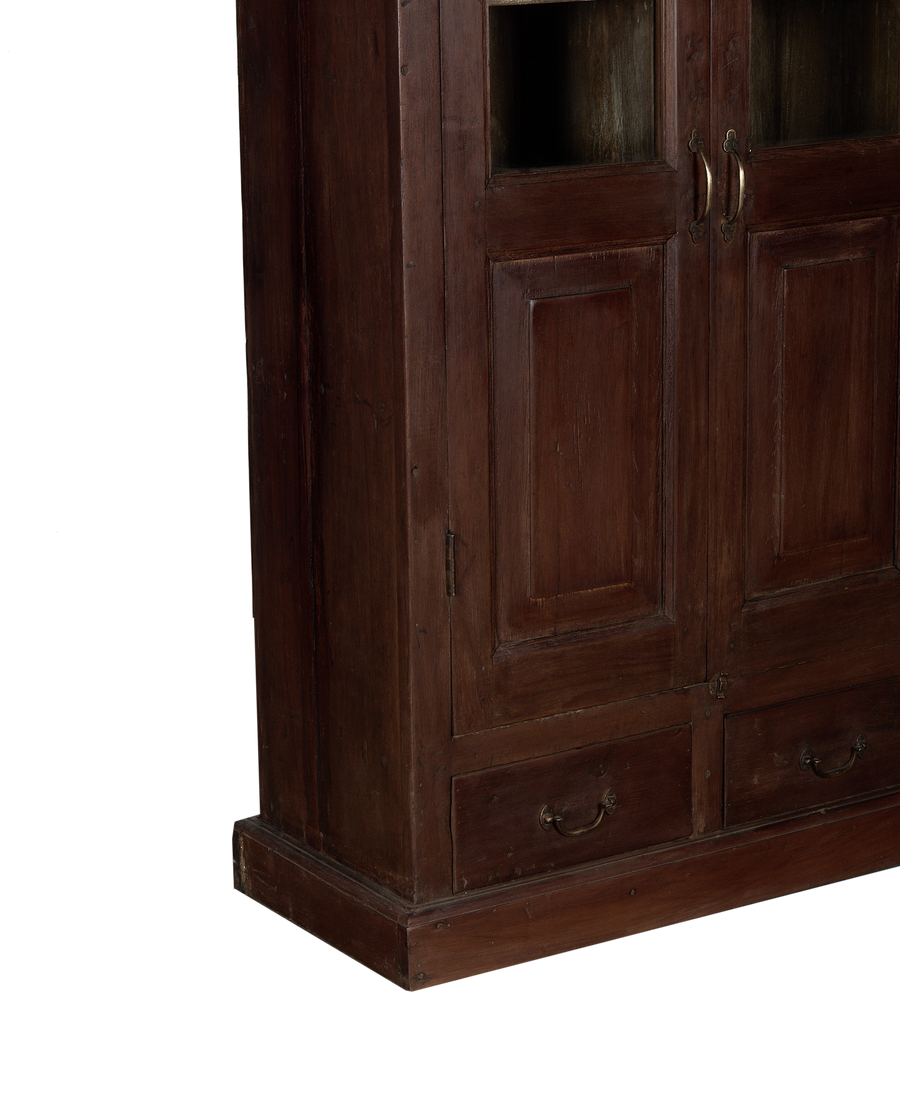 Vintage oak cabinet from India, showing bottom drawers with brass handles and rustic wood texture.