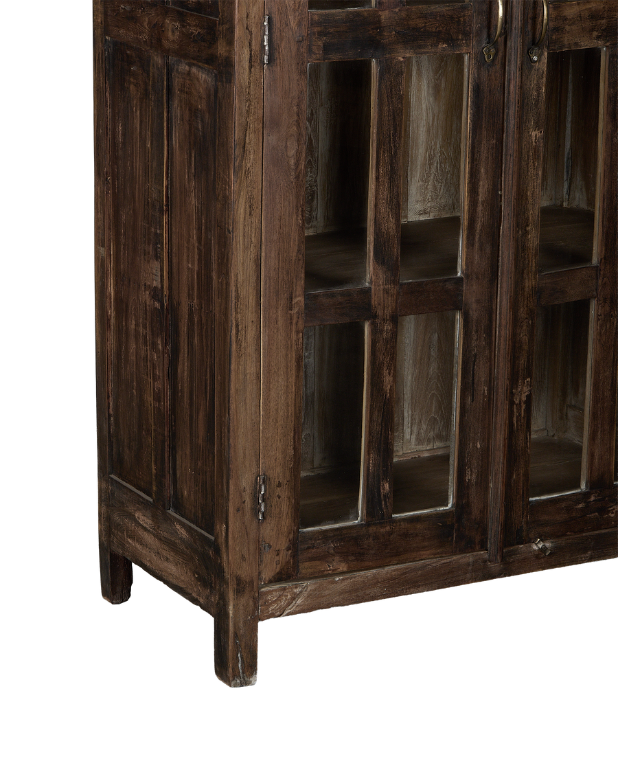 Vintage Indian oak cabinet showcasing glass-front doors, rustic wood texture, and aged brass handles.
