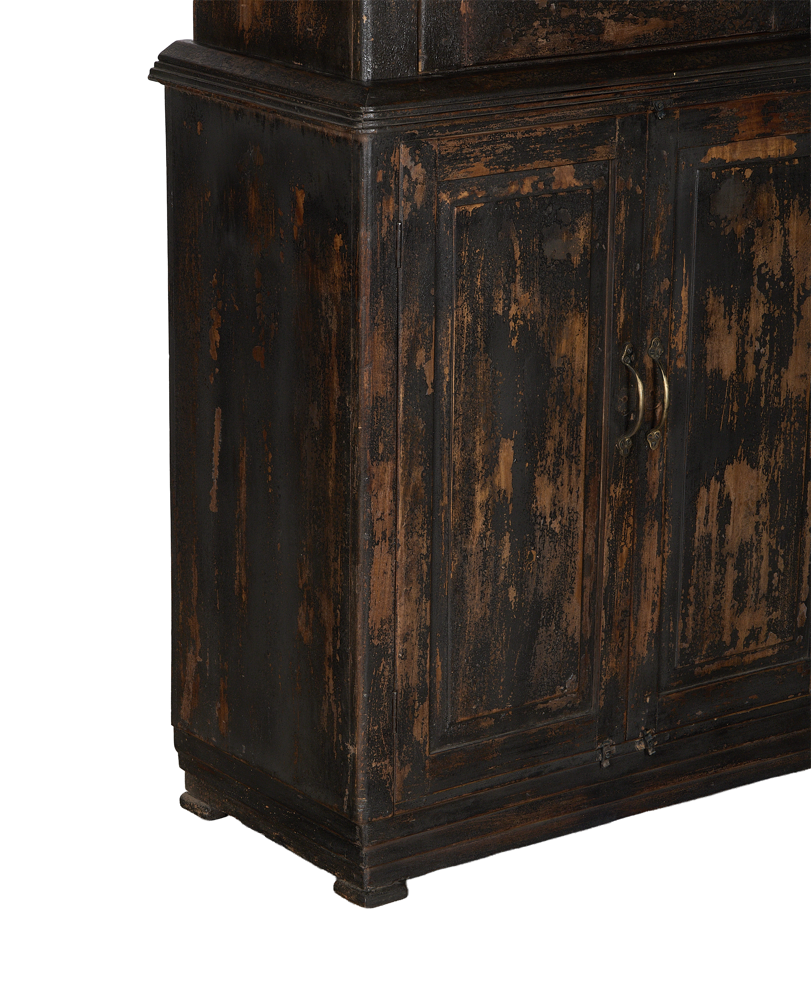 Vintage Indian oak cabinet bottom showing distressed black stain, panel doors, and brass handles.