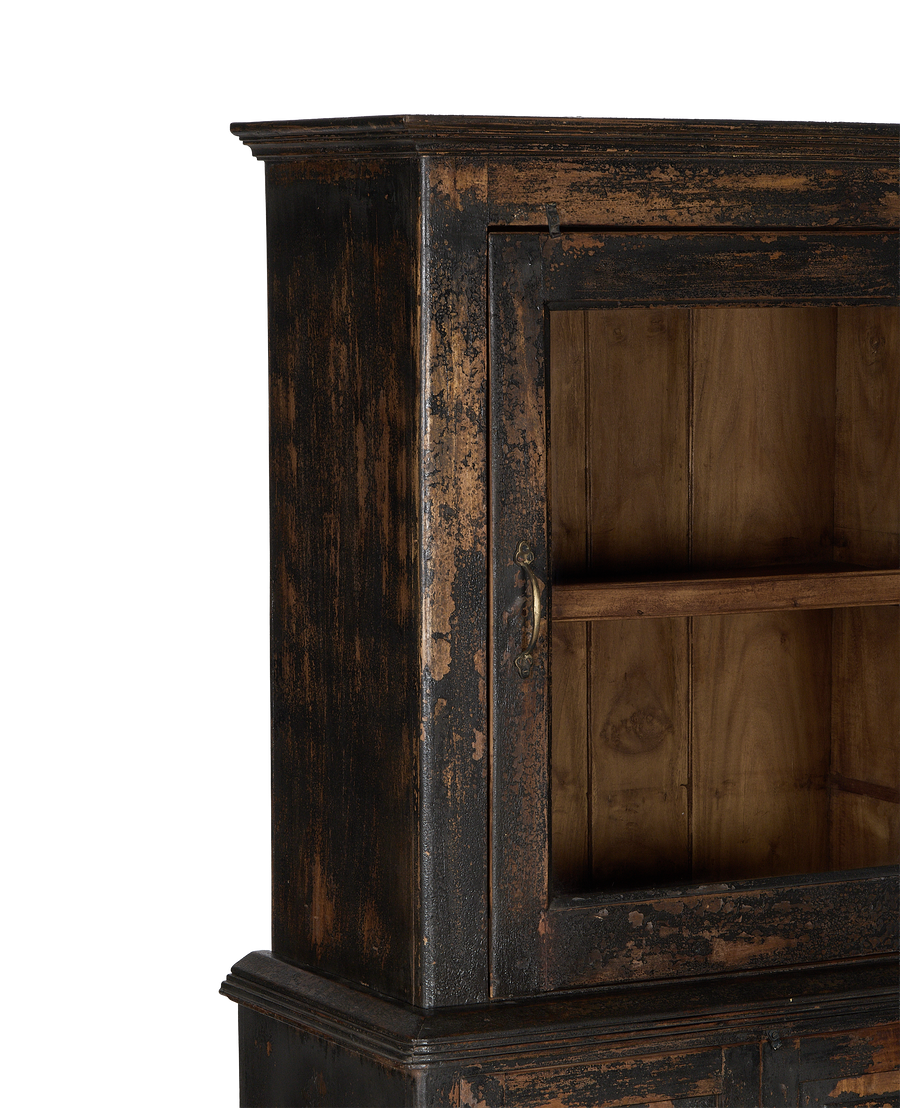 Distressed vintage Indian oak cabinet with partially open door, revealing interior shelves and aged brass handle.