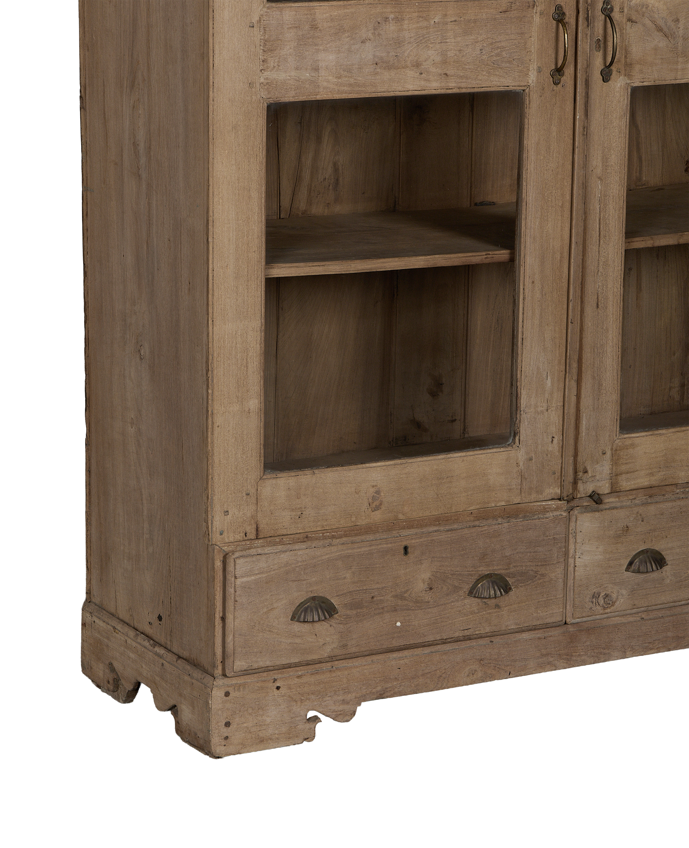 Vintage Indian oak wood cabinet, close-up of aged drawers with ornate shell pulls and natural patina.