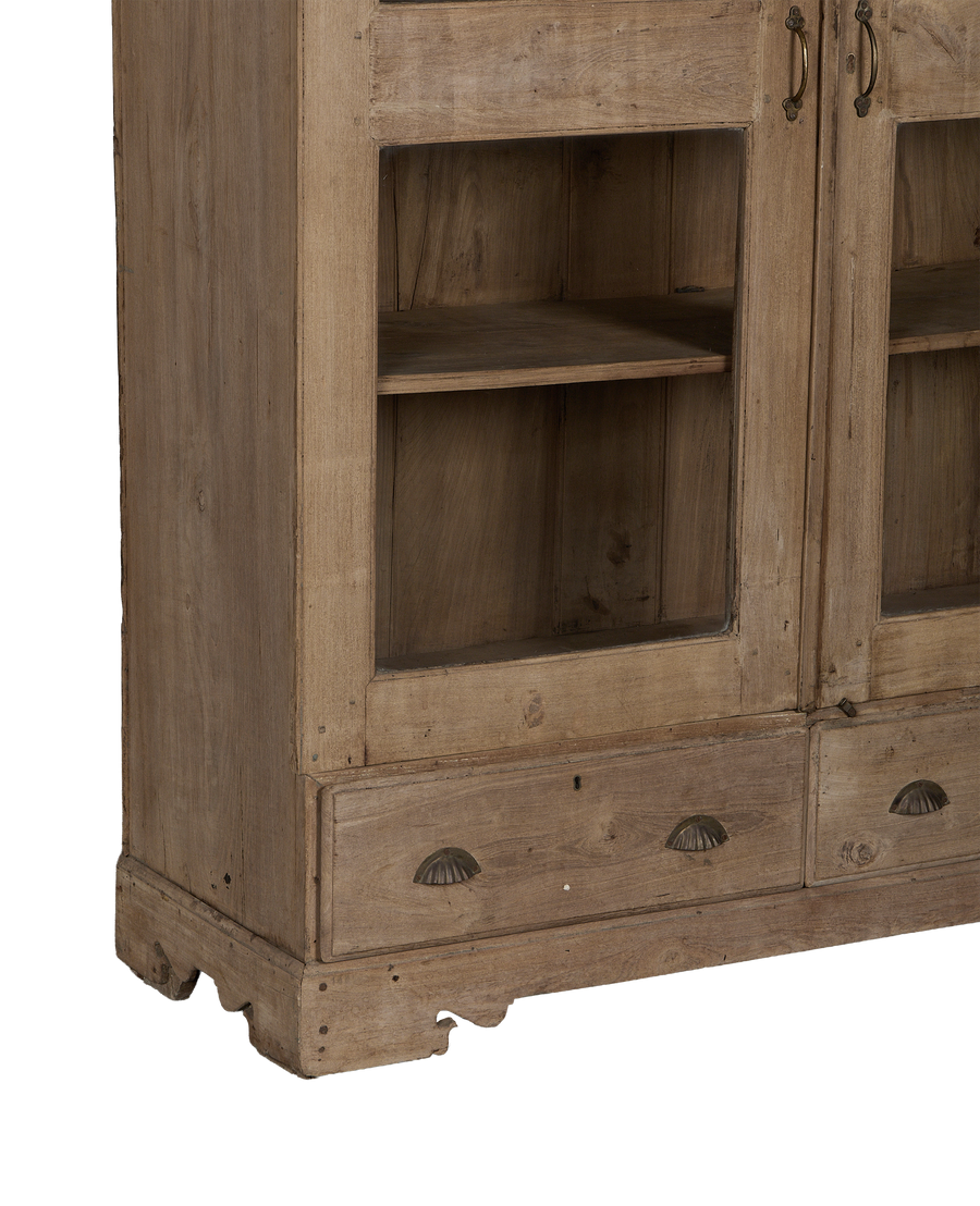 Vintage Indian oak wood cabinet, close-up of aged drawers with ornate shell pulls and natural patina.
