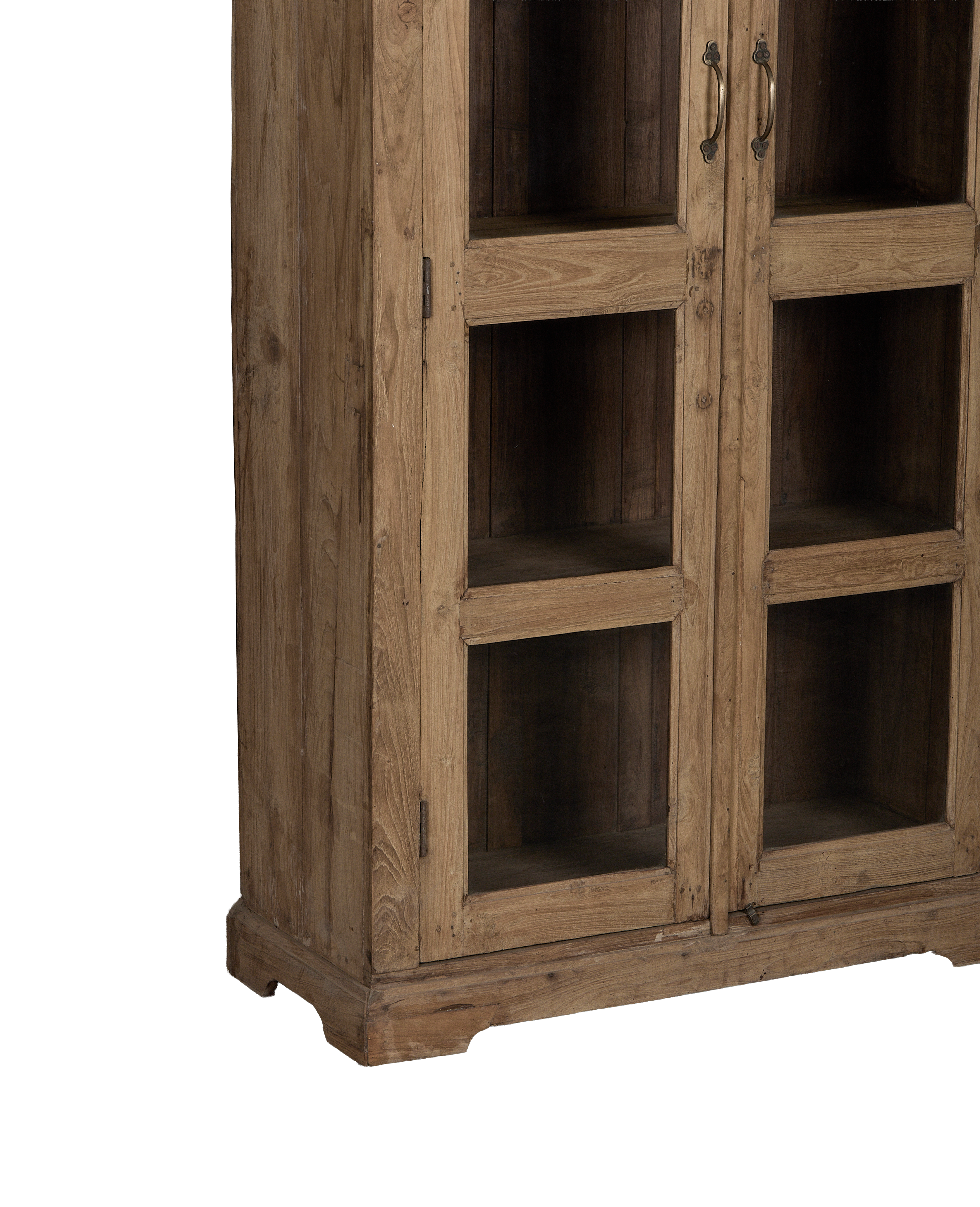 Vintage Indian oak cabinet details: glass doors, ornate brass handles, and sturdy base.