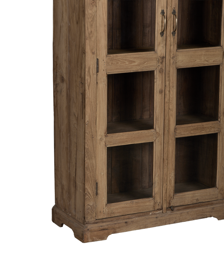 Vintage Indian oak cabinet details: glass doors, ornate brass handles, and sturdy base.