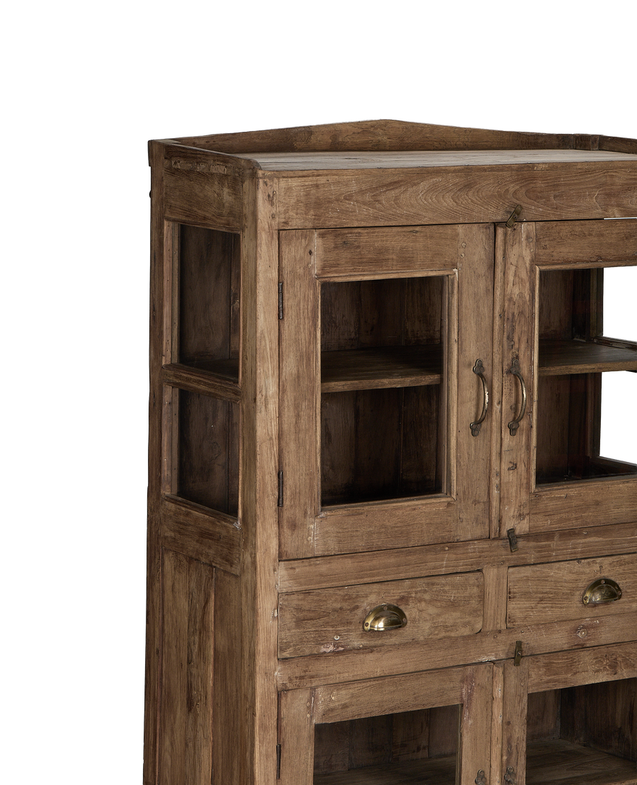 Vintage Indian oak cabinet featuring glass-paneled doors, exposed shelves, and brass hardware detail.