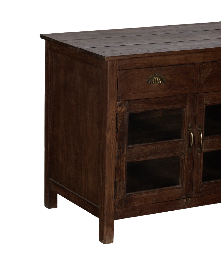 Vintage Indian oak sideboard, angled close-up highlighting drawer with clam-shell pull and glass doors.
