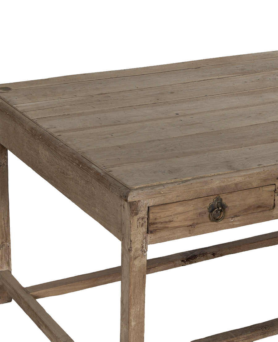 Vintage bleached oak wood desk from India, showing intricate brass drawer pull and distressed wood grain.