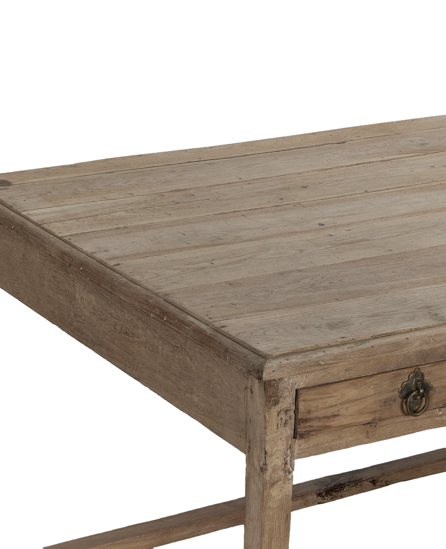 Vintage bleached oak desk, close-up with worn brass drawer pull.