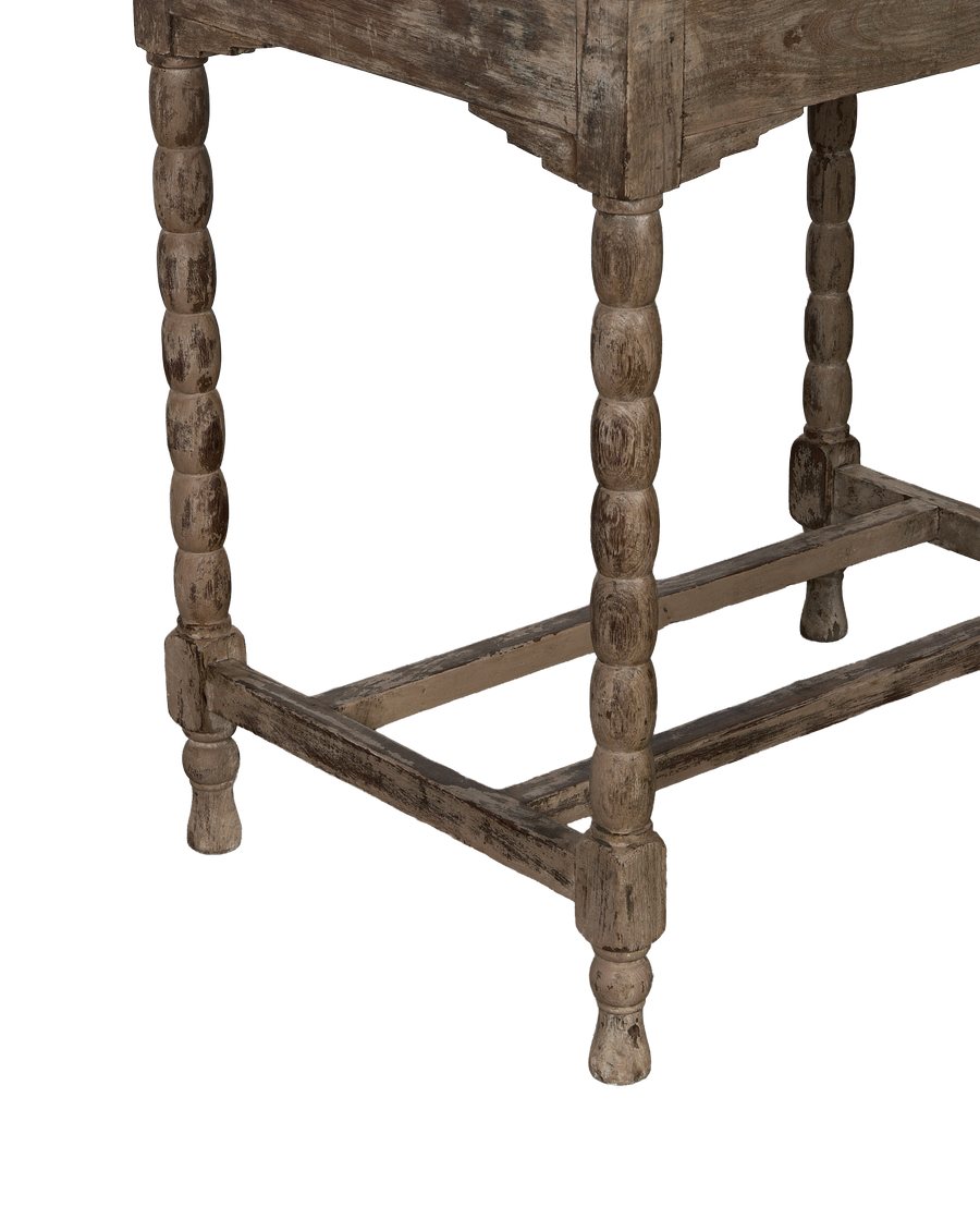 Vintage Indian bleached oak side table, showing distressed bobbin legs and base support detail.