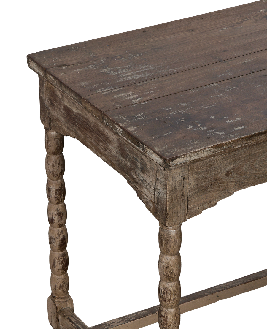 Vintage Indian bleached oak side table showing the distressed top and turned leg.