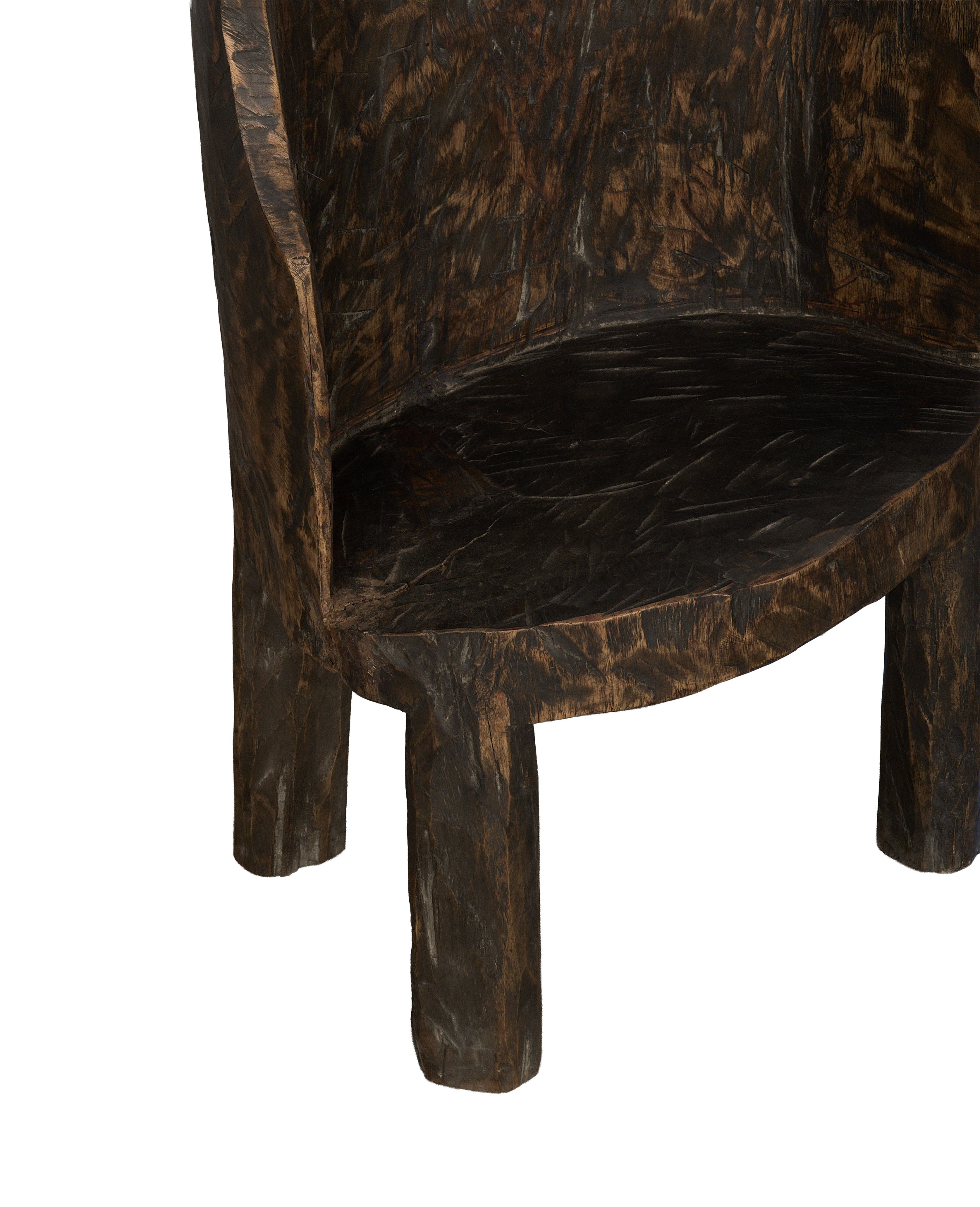 Vintage Nagaland oak chair's curved seat and sturdy carved legs, showing grain.