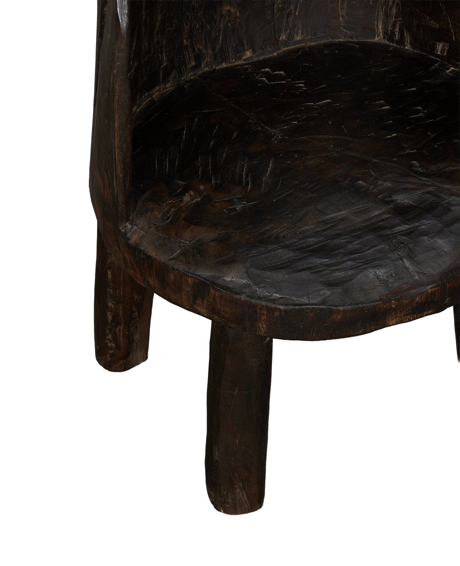 Vintage Nagaland oak chair detail, showing textured aged dark wood seat and sturdy base.