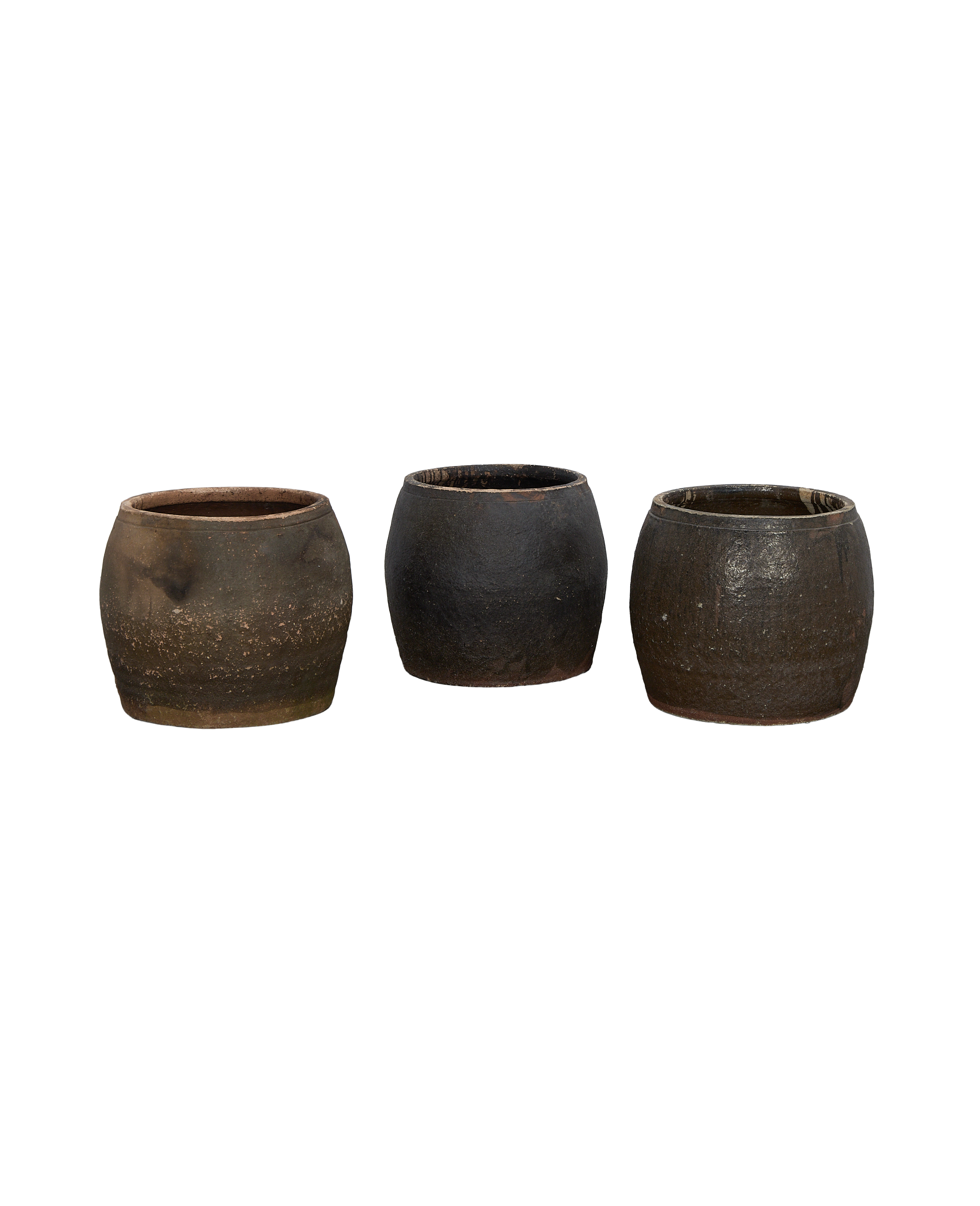 Three distressed vintage Chinese terracotta planters in various earth tones on black background.