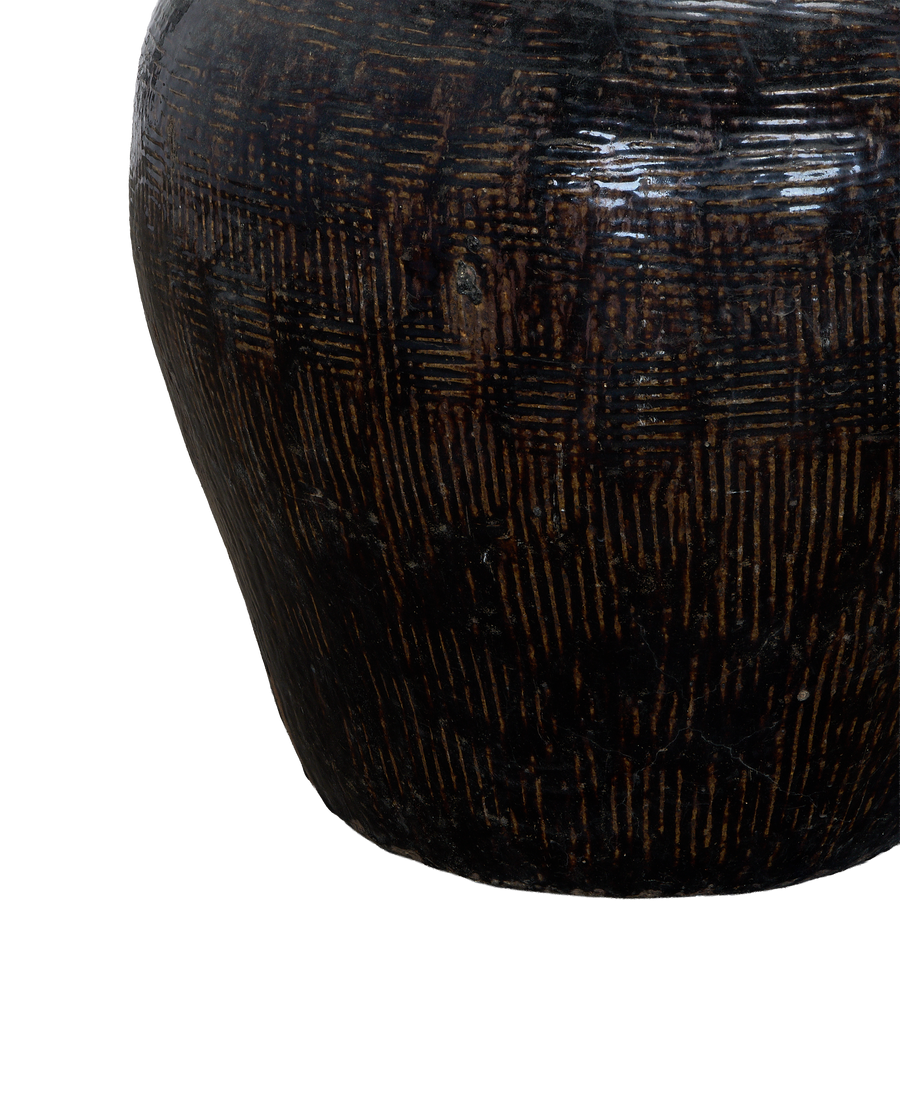 Close-up of vintage Chinese ceramic jar with textured, weathered dark brown glaze.