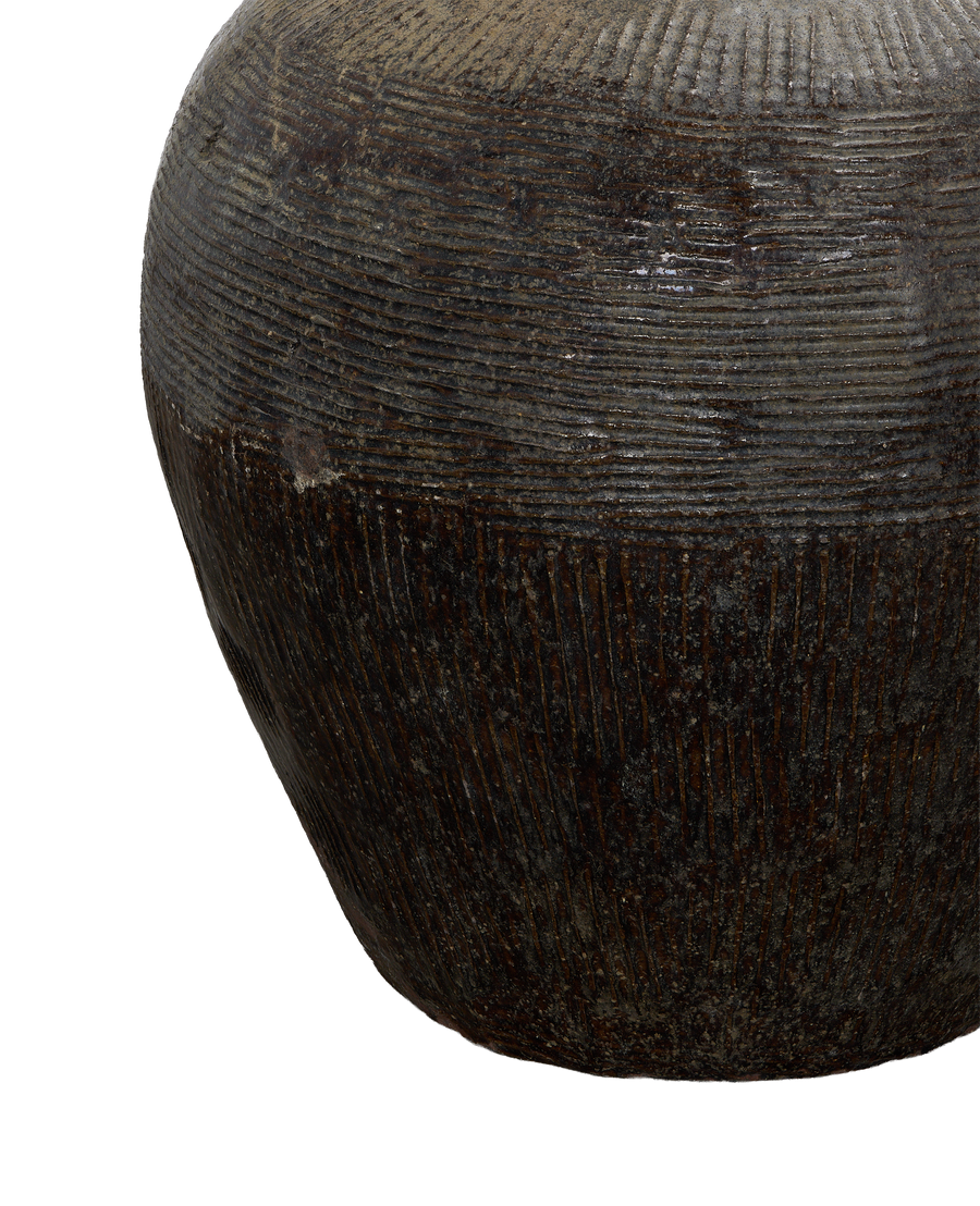 Close-up of vintage Chinese Willow Jar's rough, textured surface and dark glaze.