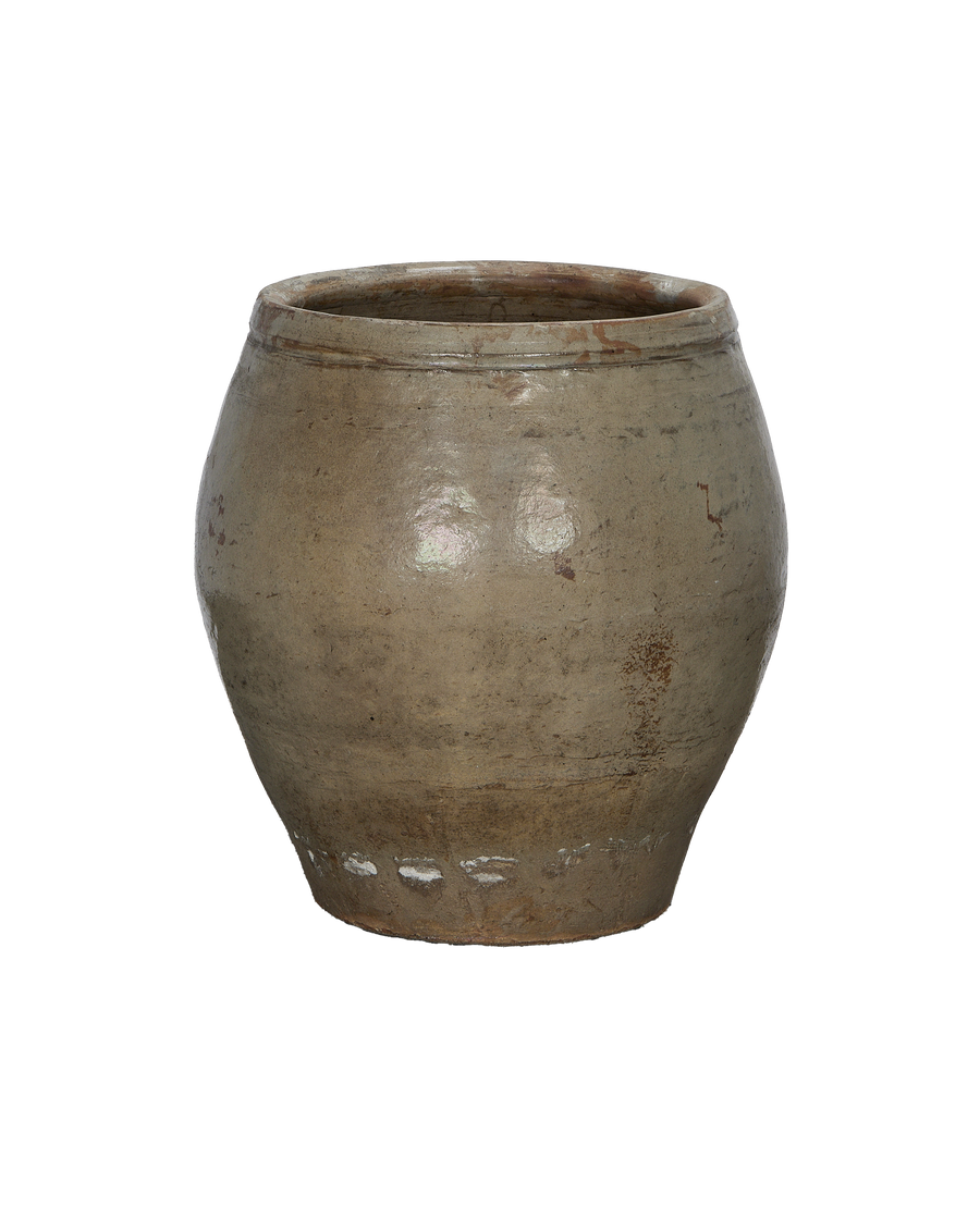 Vintage Chinese ceramic planter, showing rough textured exterior and rim detail on a black background.