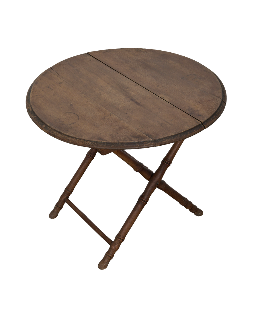 Vintage French oak bamboo folding table, showing circular top with characterful woodgrain and folding mechanism.