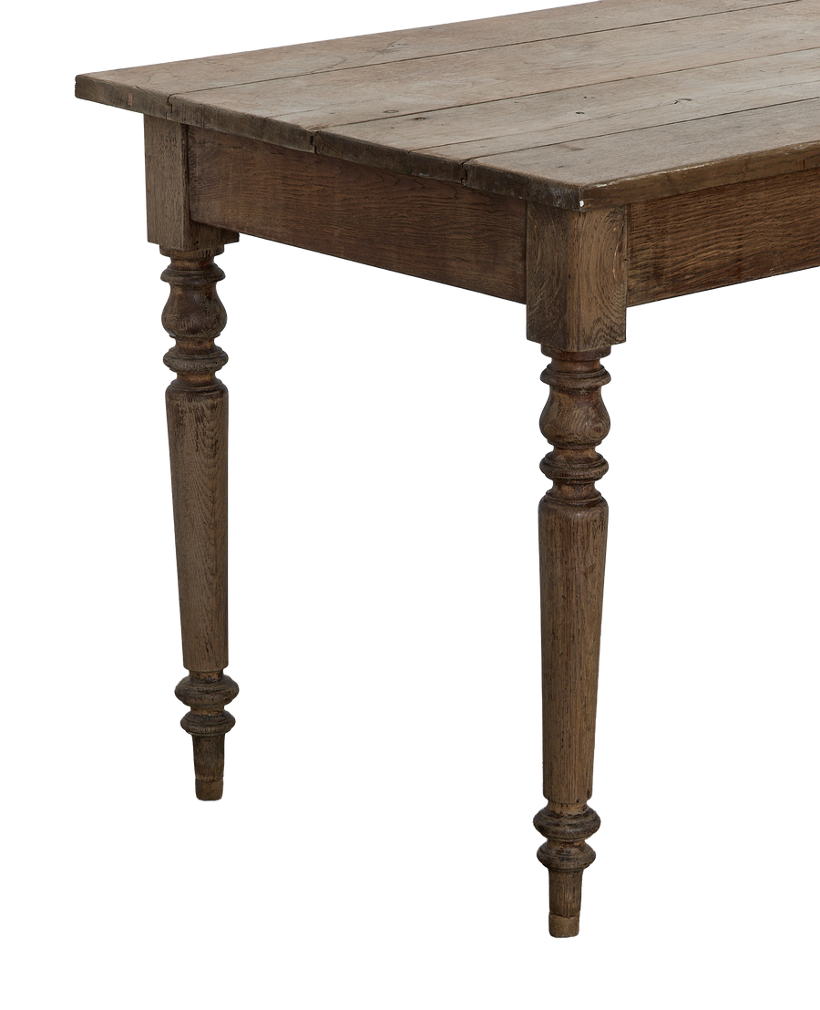 Vintage French oak farm table, showing detailed turned legs and distressed tabletop planks.
