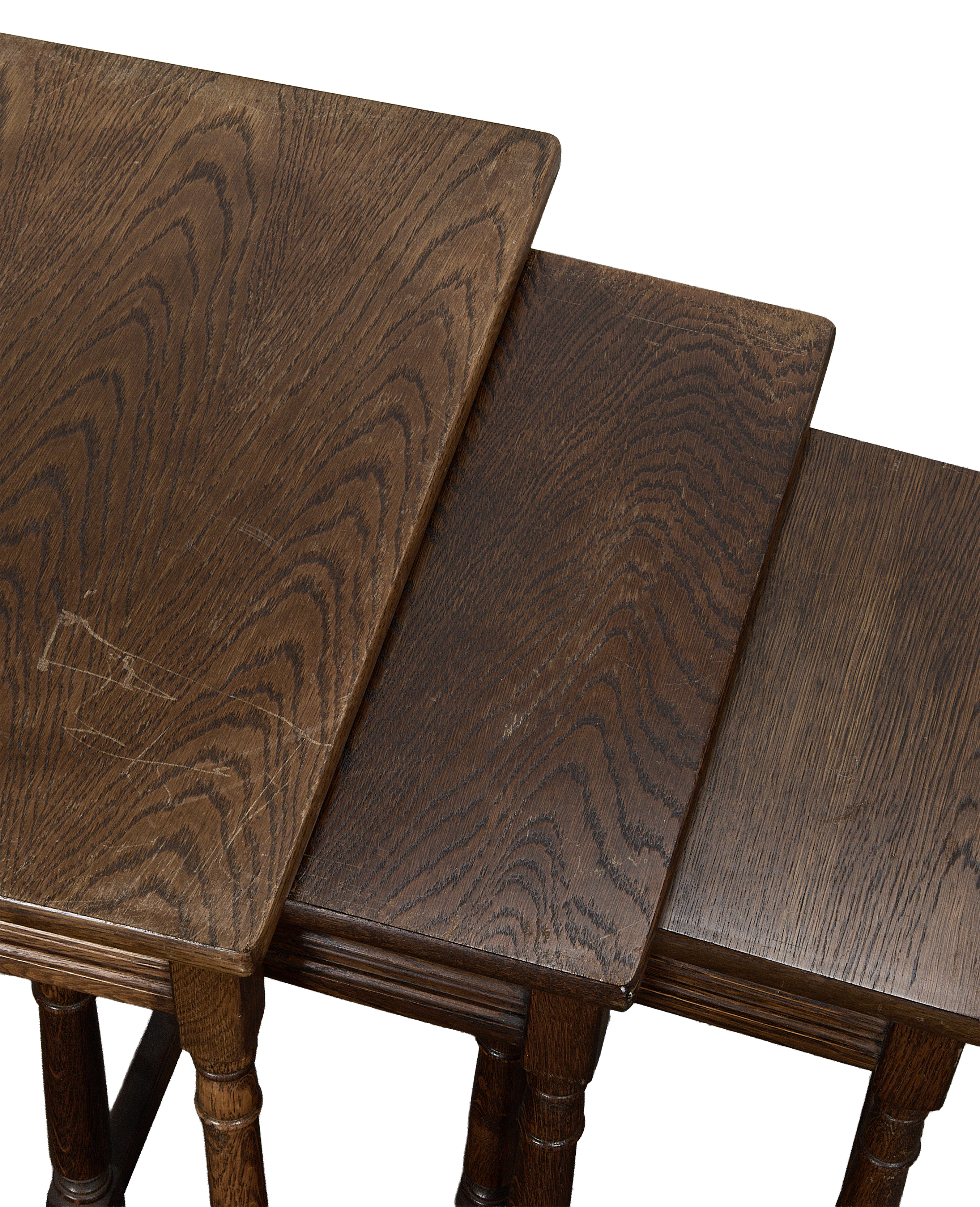 Vintage French oak nesting tables, showing individual tops, grain, and general antique wear.