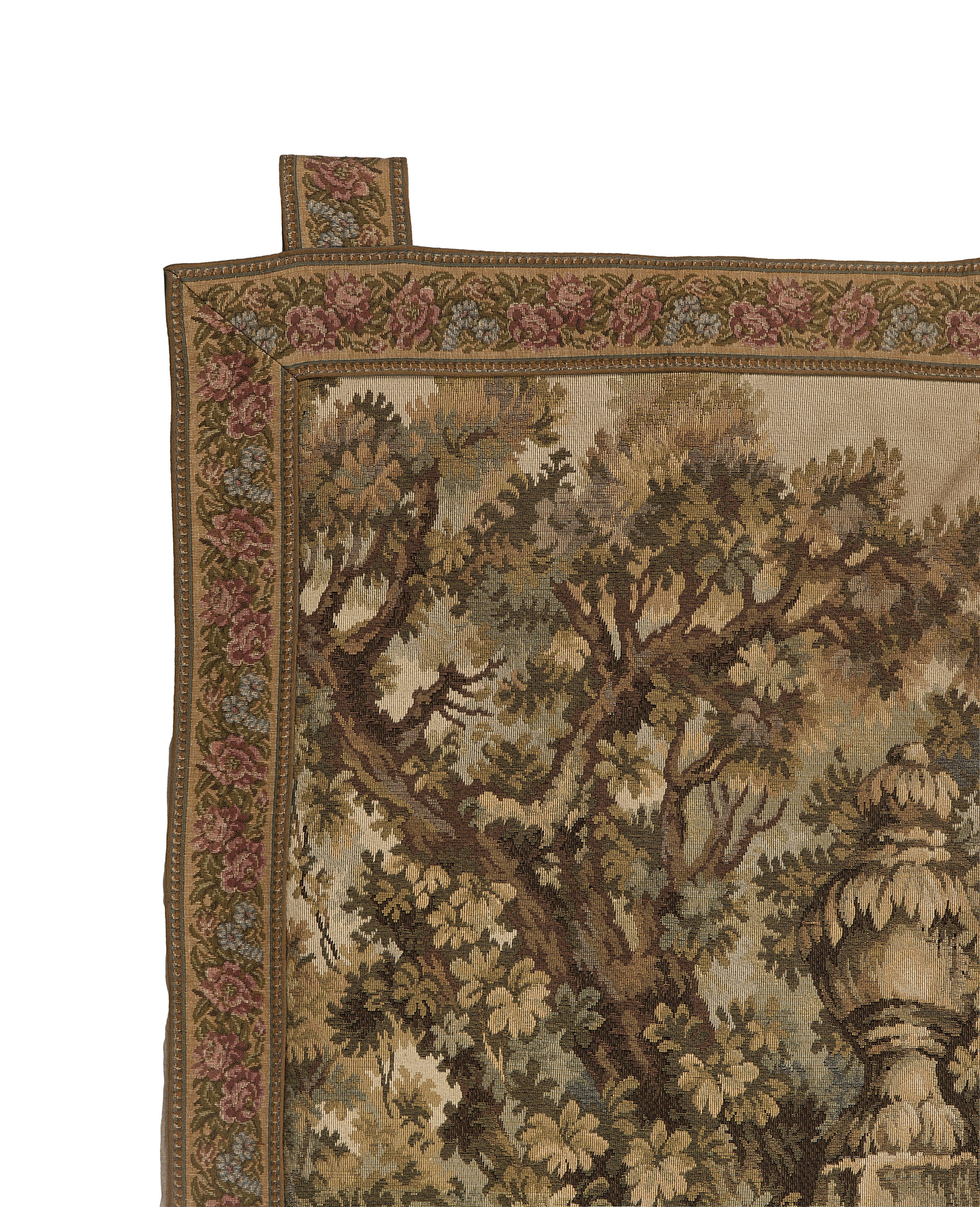 Vintage French tapestry corner with floral border and intricate oak tree weaving.