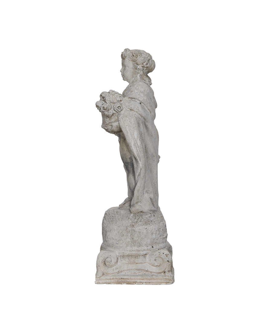 Vintage gray concrete girl statue from France, profile view, showing floral basket.