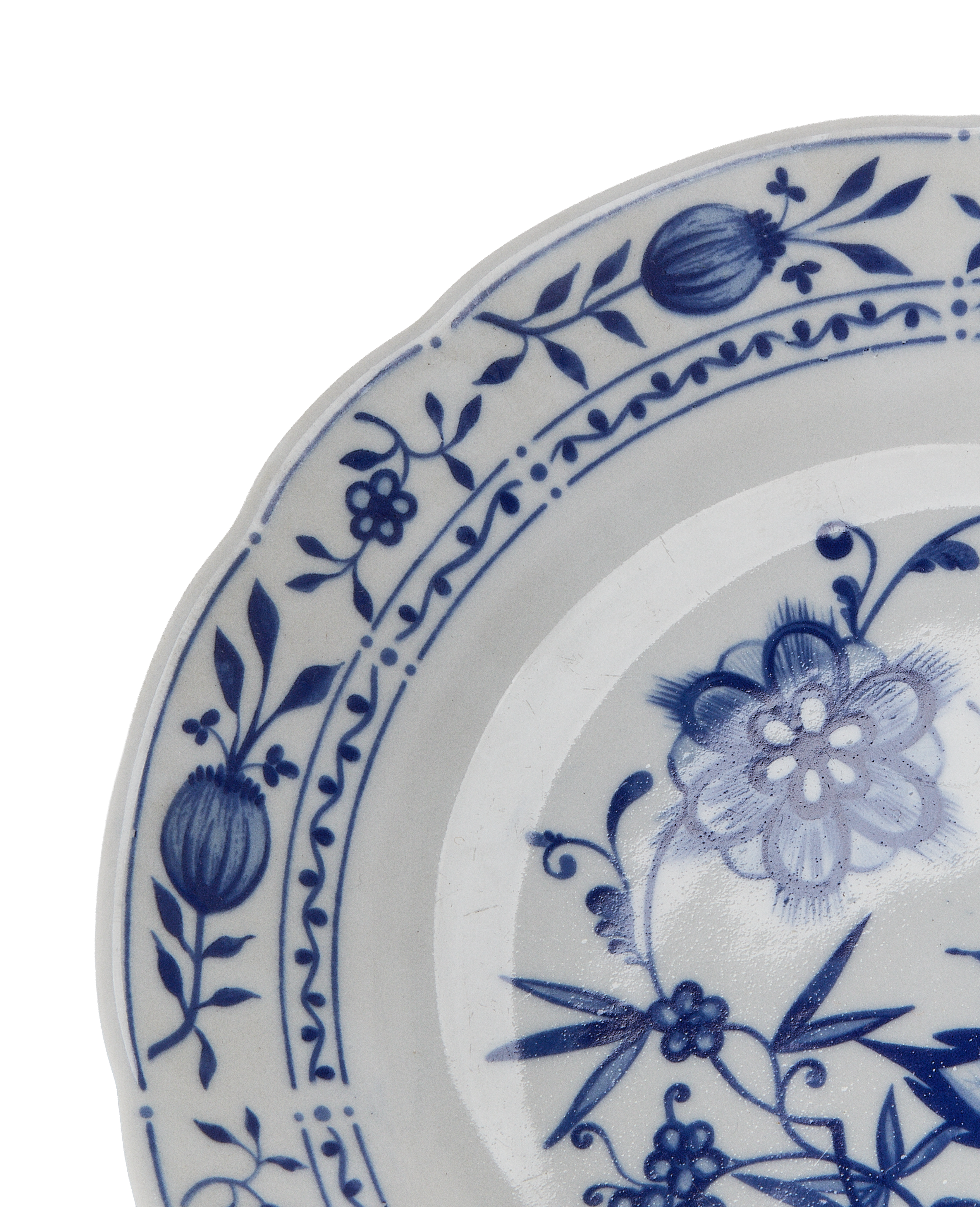 Close-up of vintage French blue and white floral china dishware rim details.