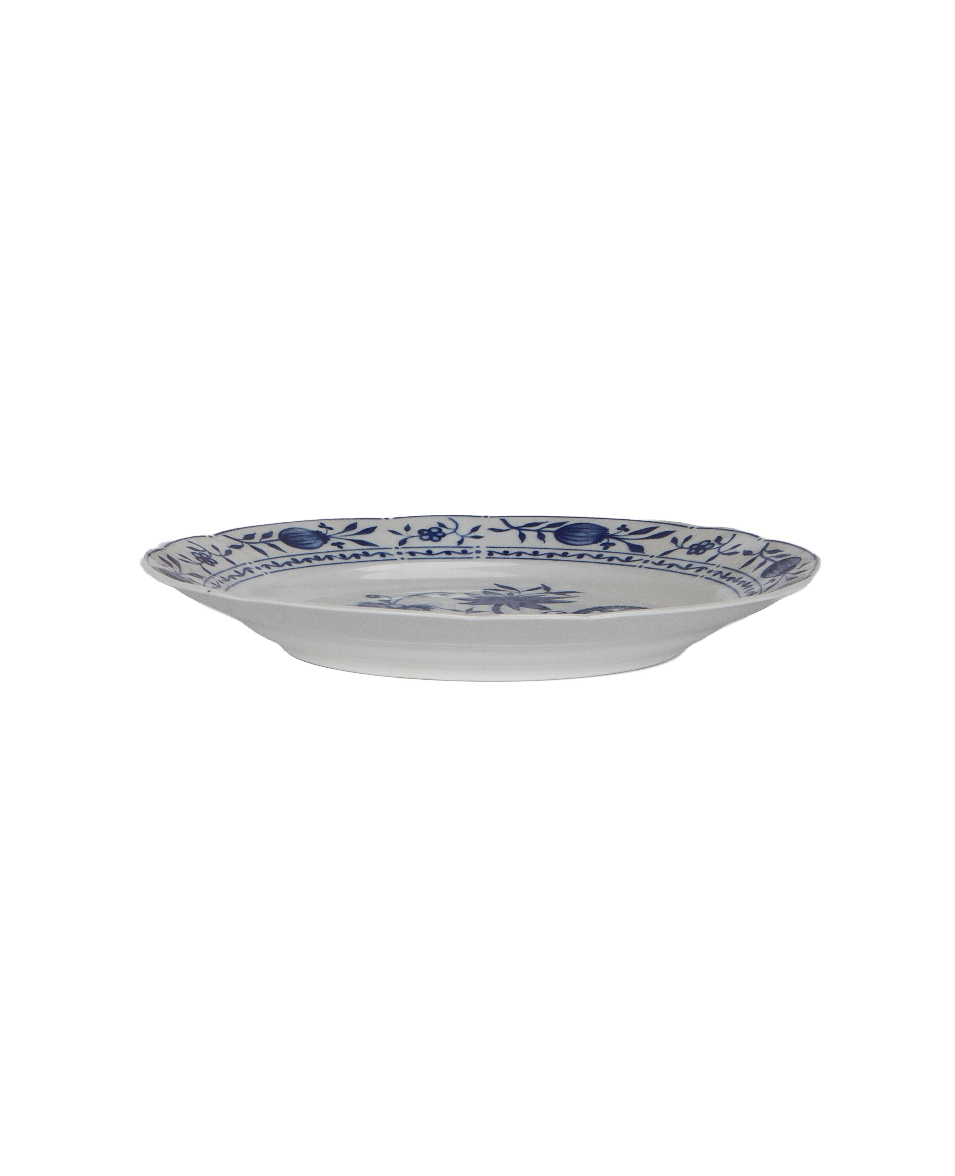 Vintage French porcelain plate side view, blue floral border, showing raised rim detail.