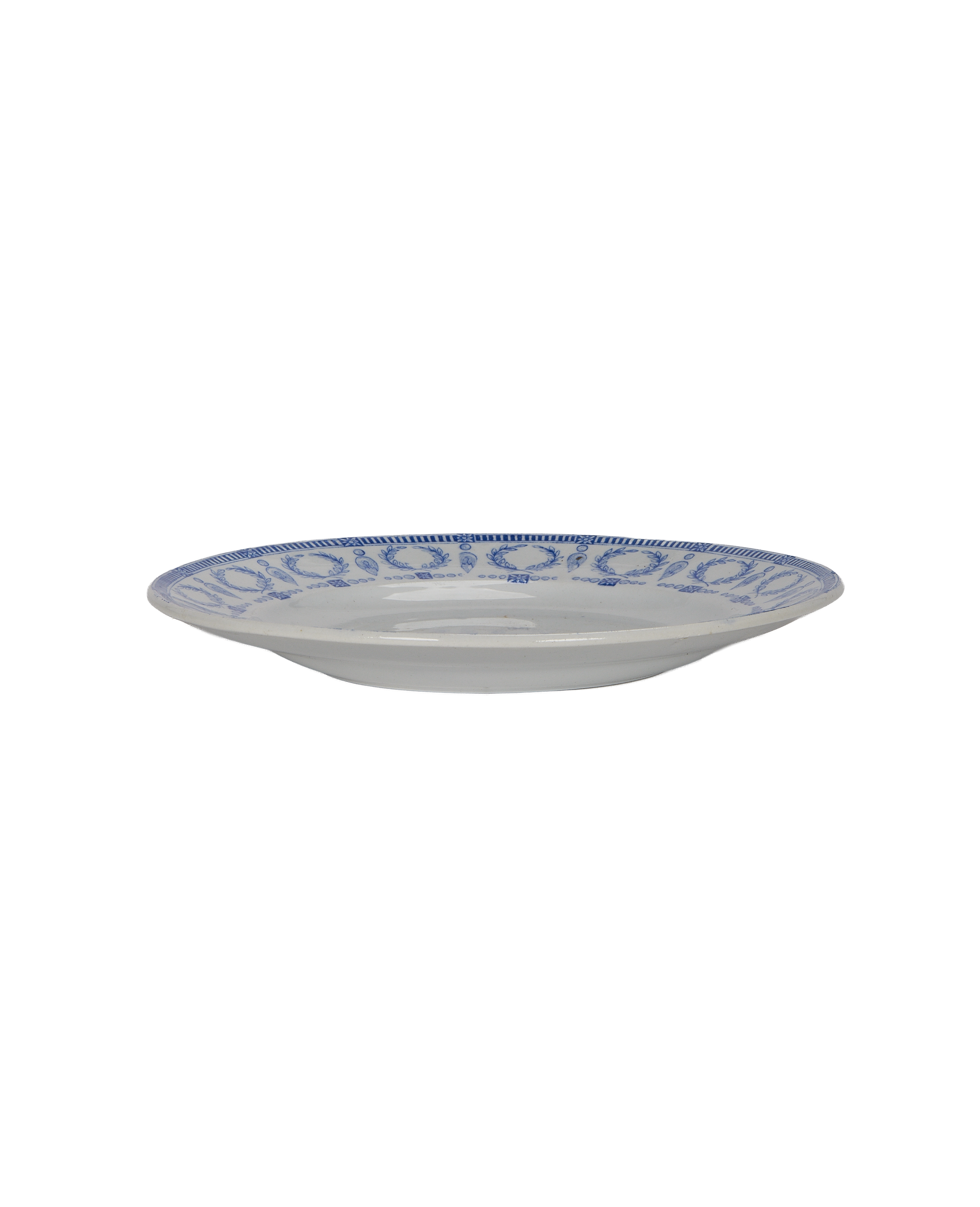 Vintage French blue and white plate, side view displaying decorative rim pattern.