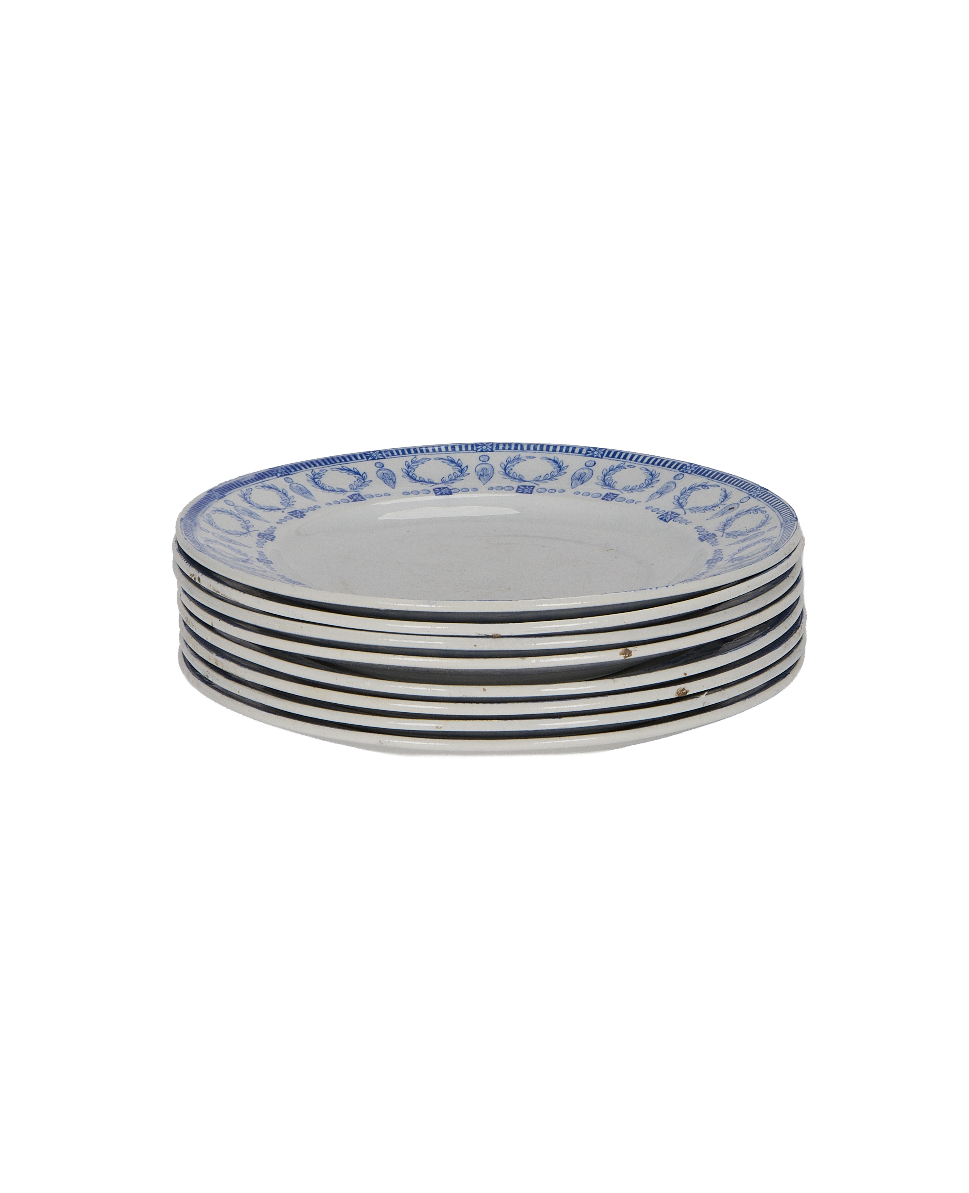 Stacked vintage French plates, blue motif, showing aged rims and signs of wear.