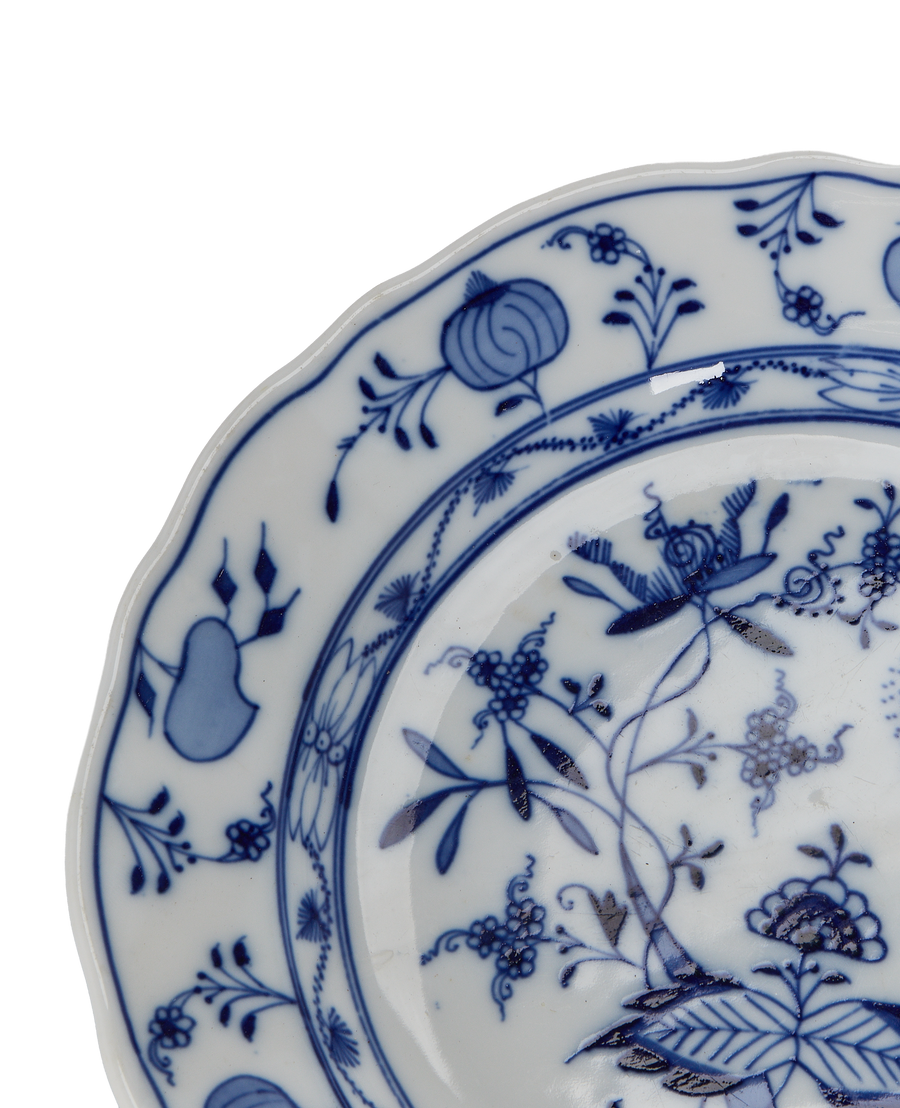 Close-up of vintage French Onion Plate showing intricate blue floral porcelain pattern.